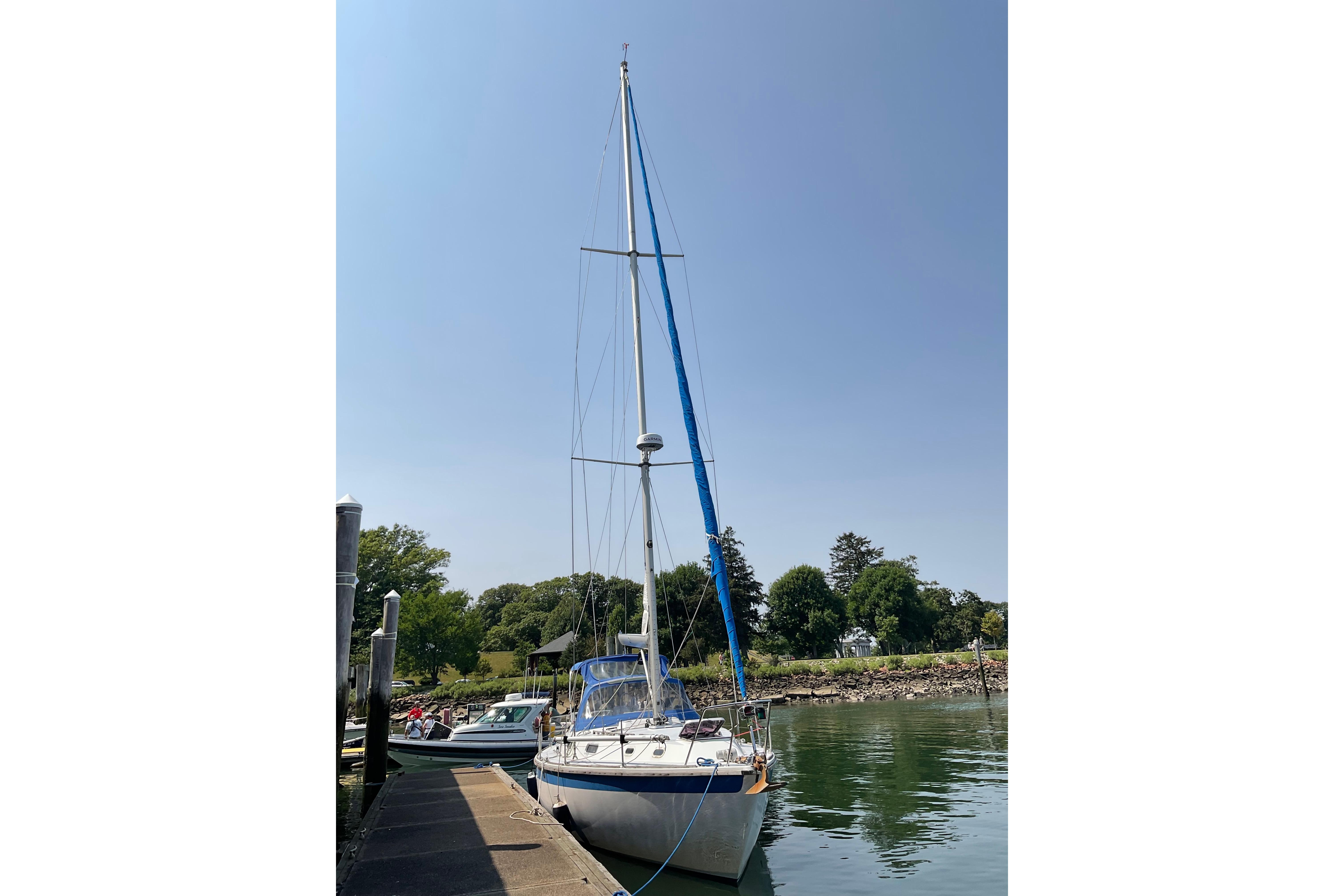 1988 Westerly Corsair 36 sailboat docked by a serene waterfront.