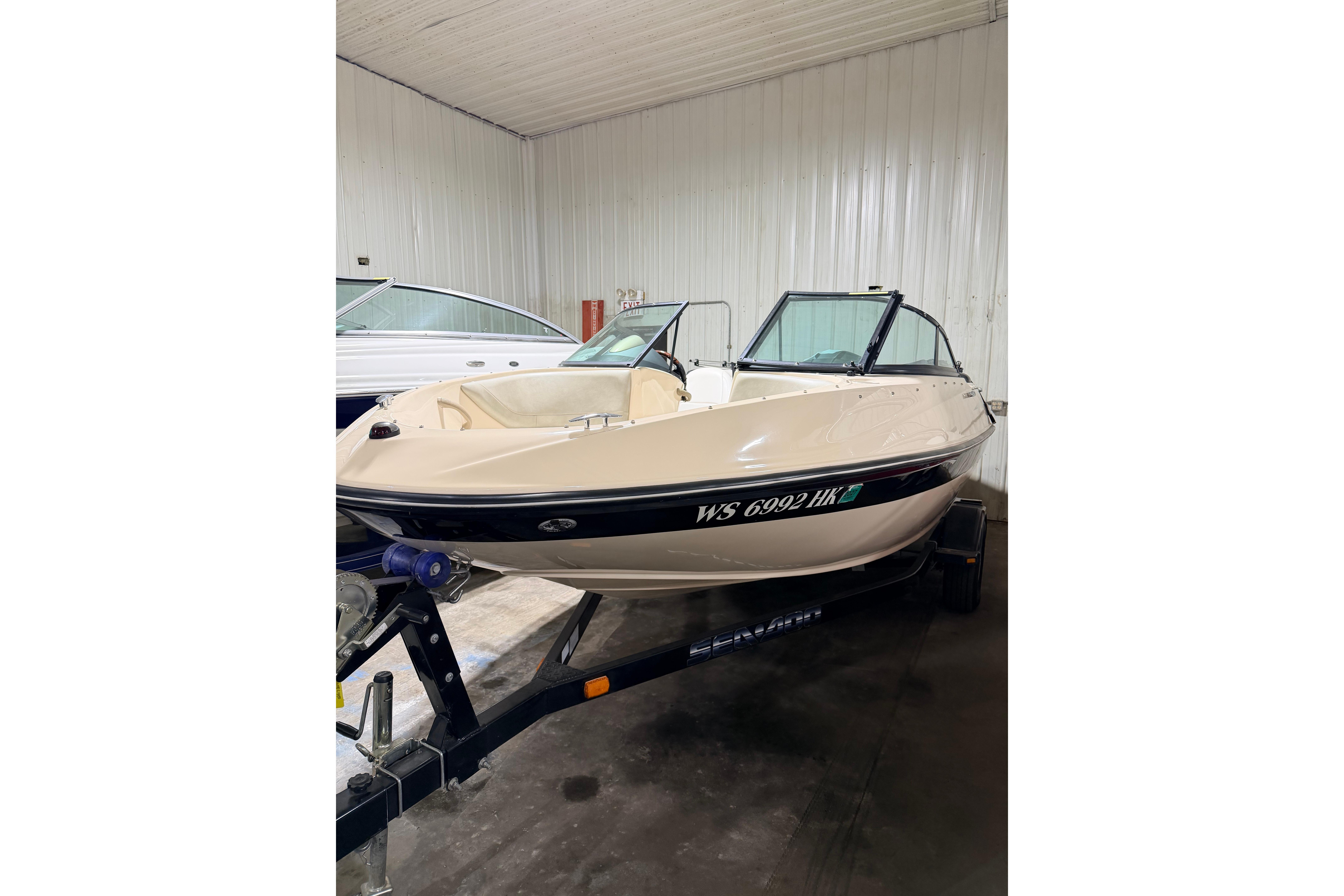 2007 Bombardier Seadoo Utopia boat on trailer in indoor storage.