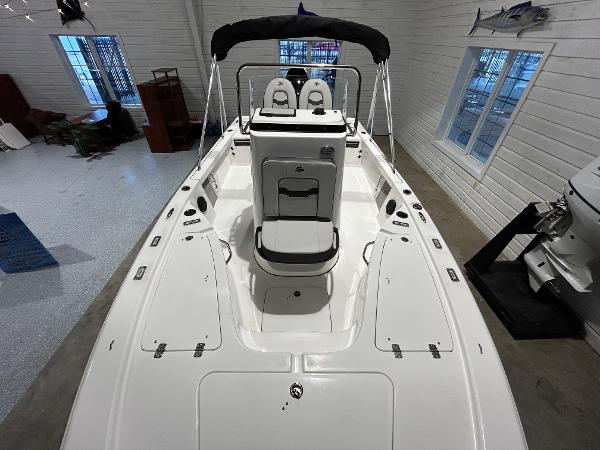 2025 Sea Pro 210 Bay boat interior with seating and storage compartments.