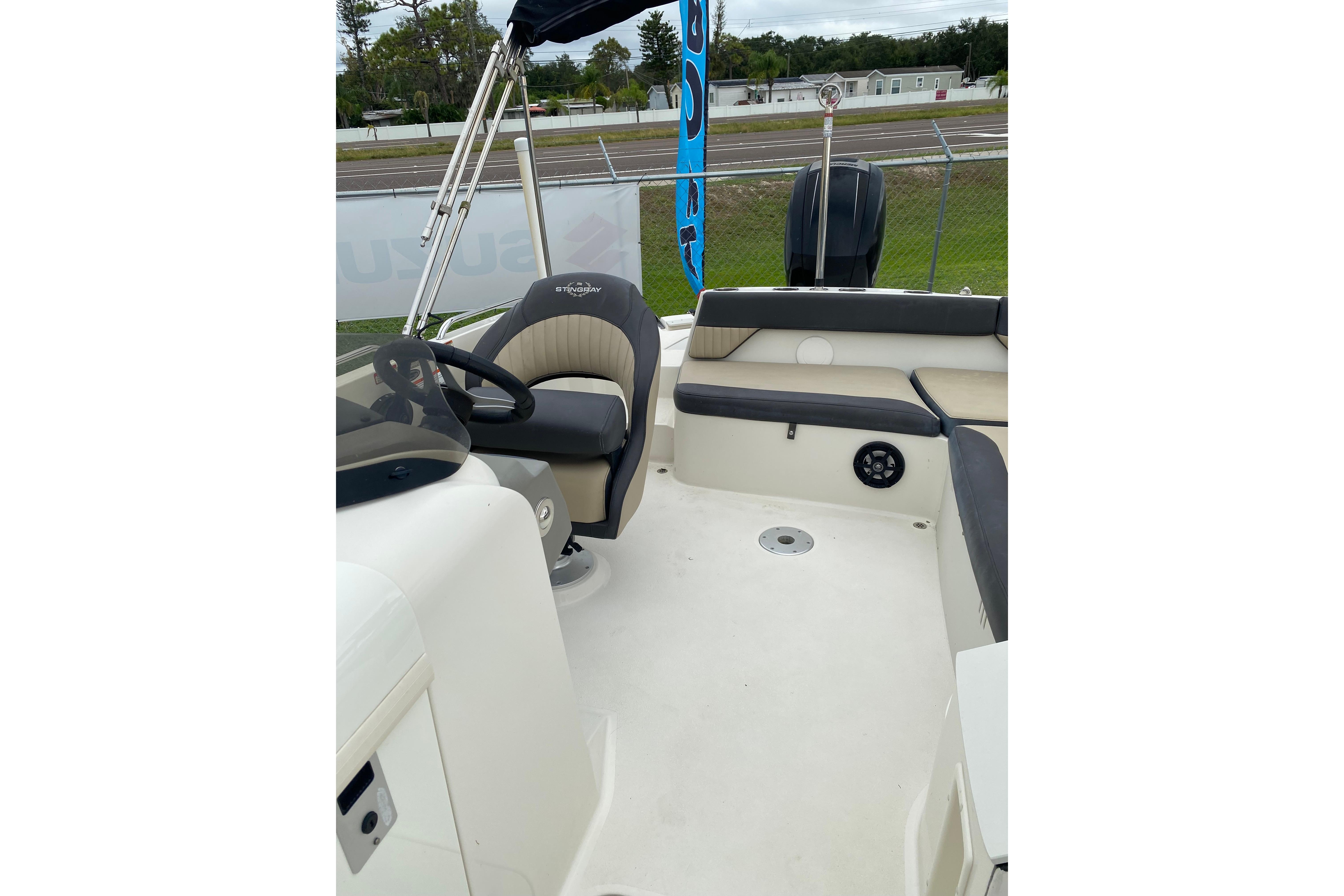 2018 Stingray 212 SC boat interior with seating and steering wheel.