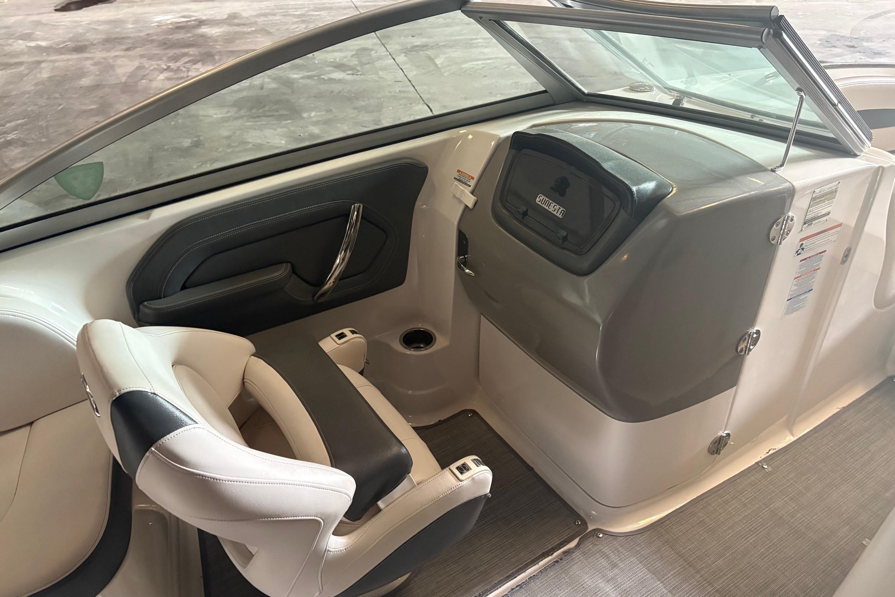 Interior of 2016 Chaparral 244 Sunesta boat, featuring seating and dashboard area.