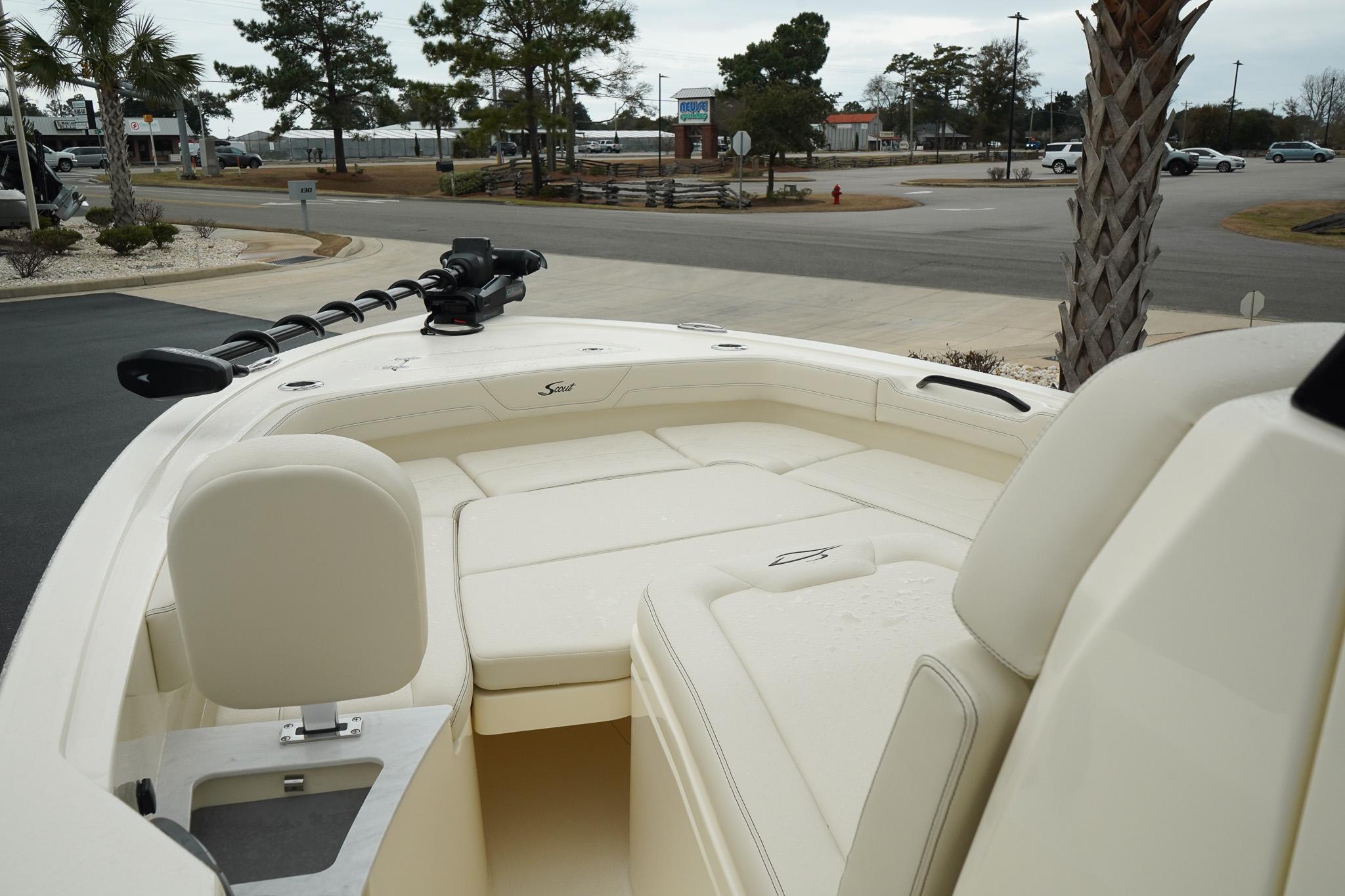 2025 Scout 261 XSS boat interior with seating and steering, parked outdoors.