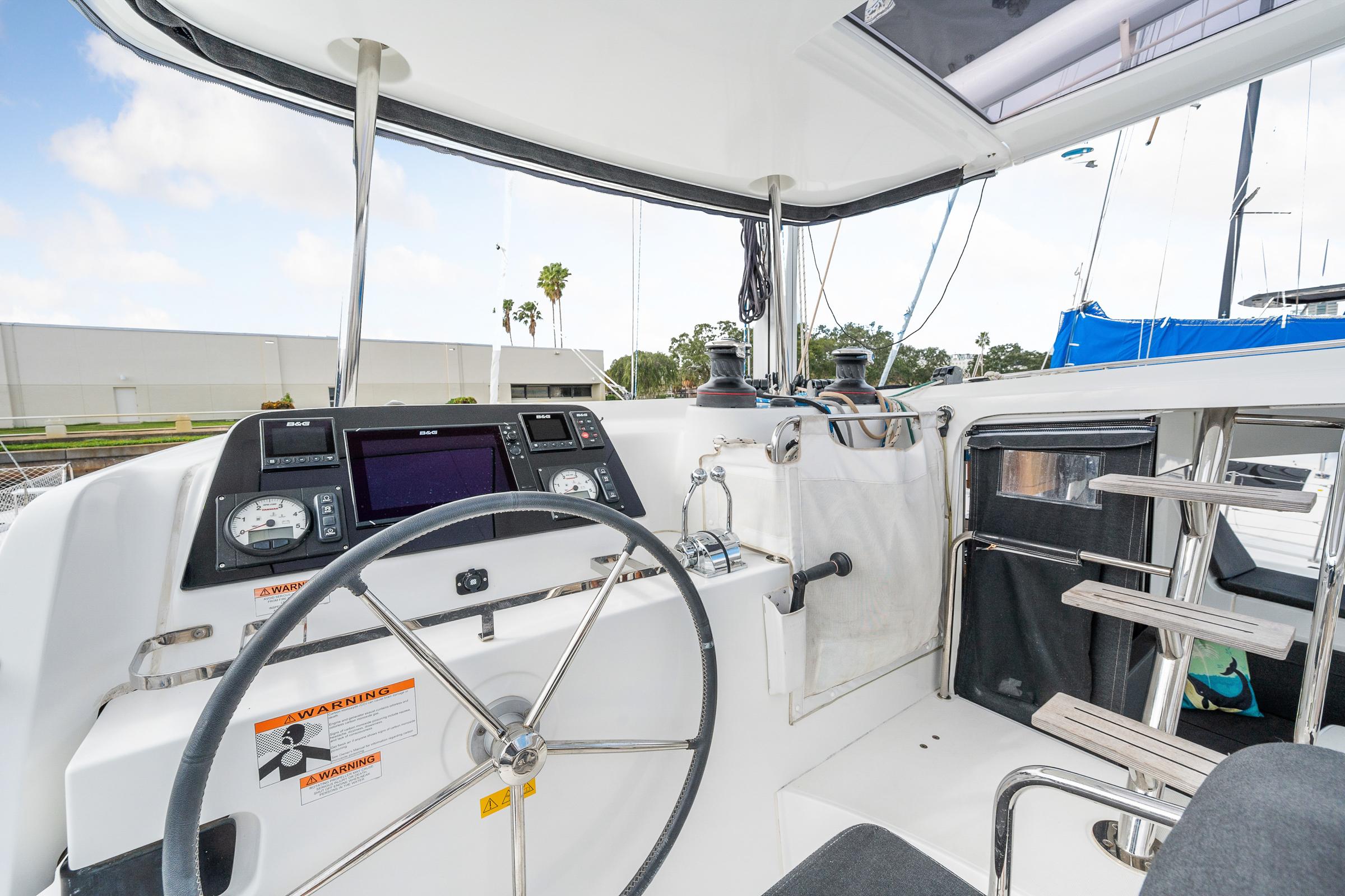Cockpit of 2018 Lagoon 42 catamaran with steering wheel and navigation instruments.