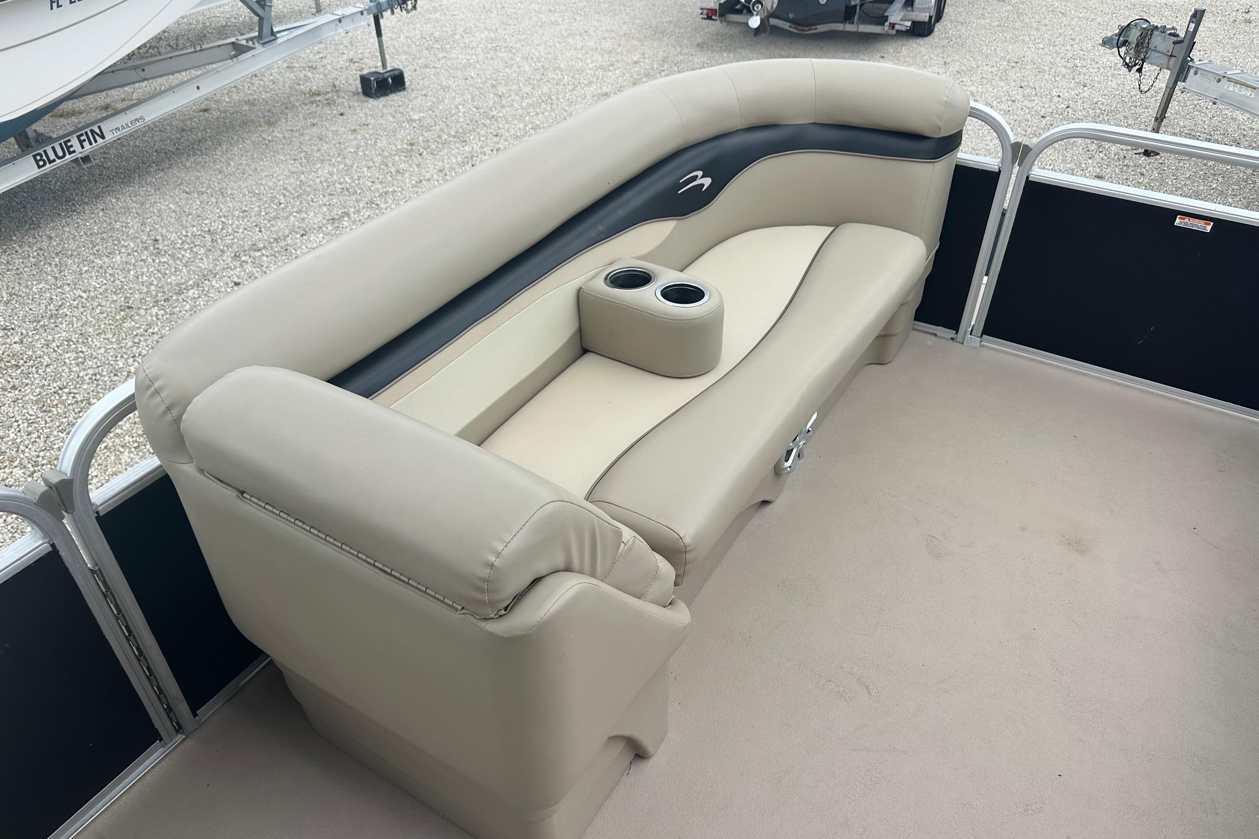 2014 Bennington S22 boat interior with beige seating and cup holders.