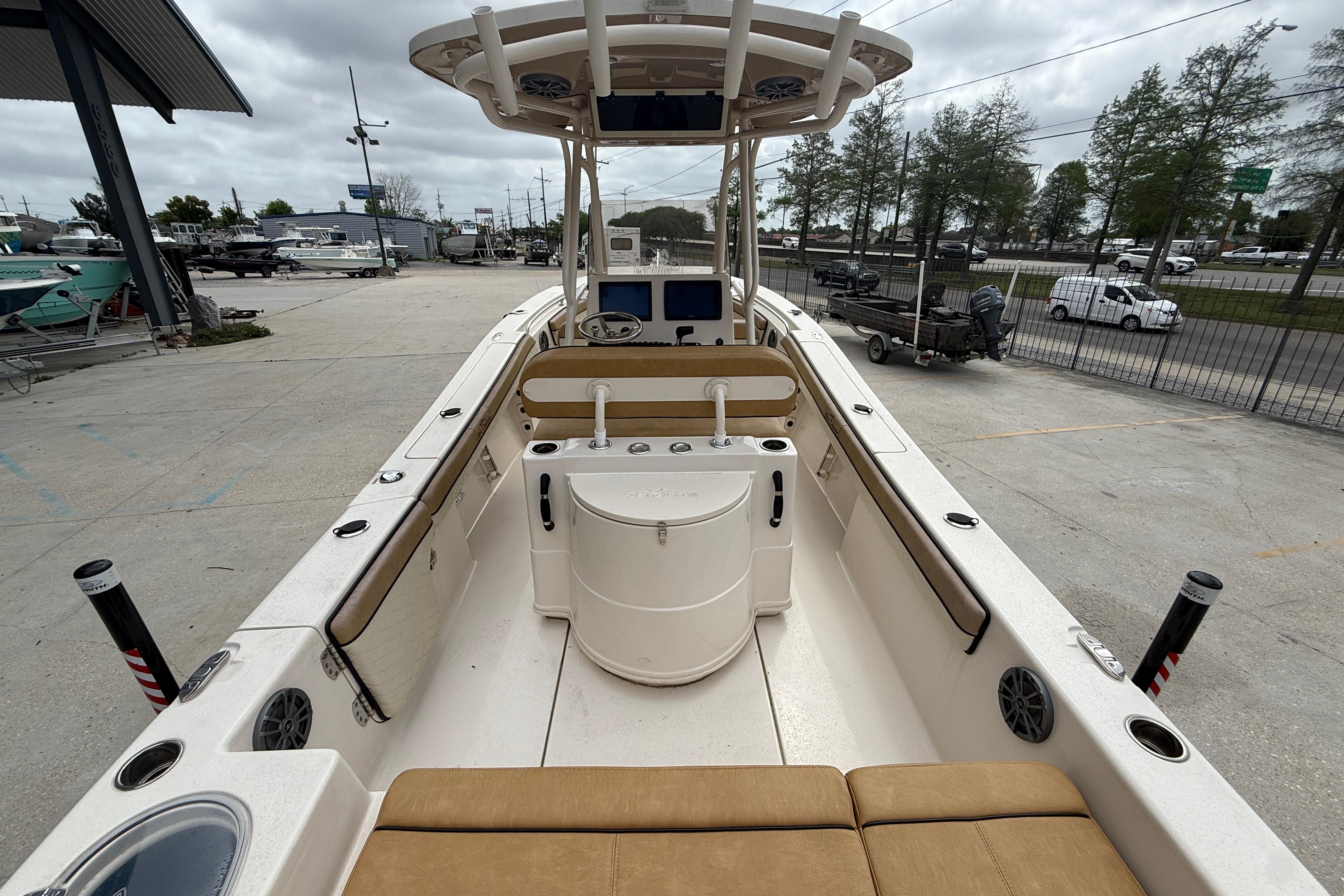 2023 SeaChaser 24 HFC boat interior with seating and console, docked outdoors.