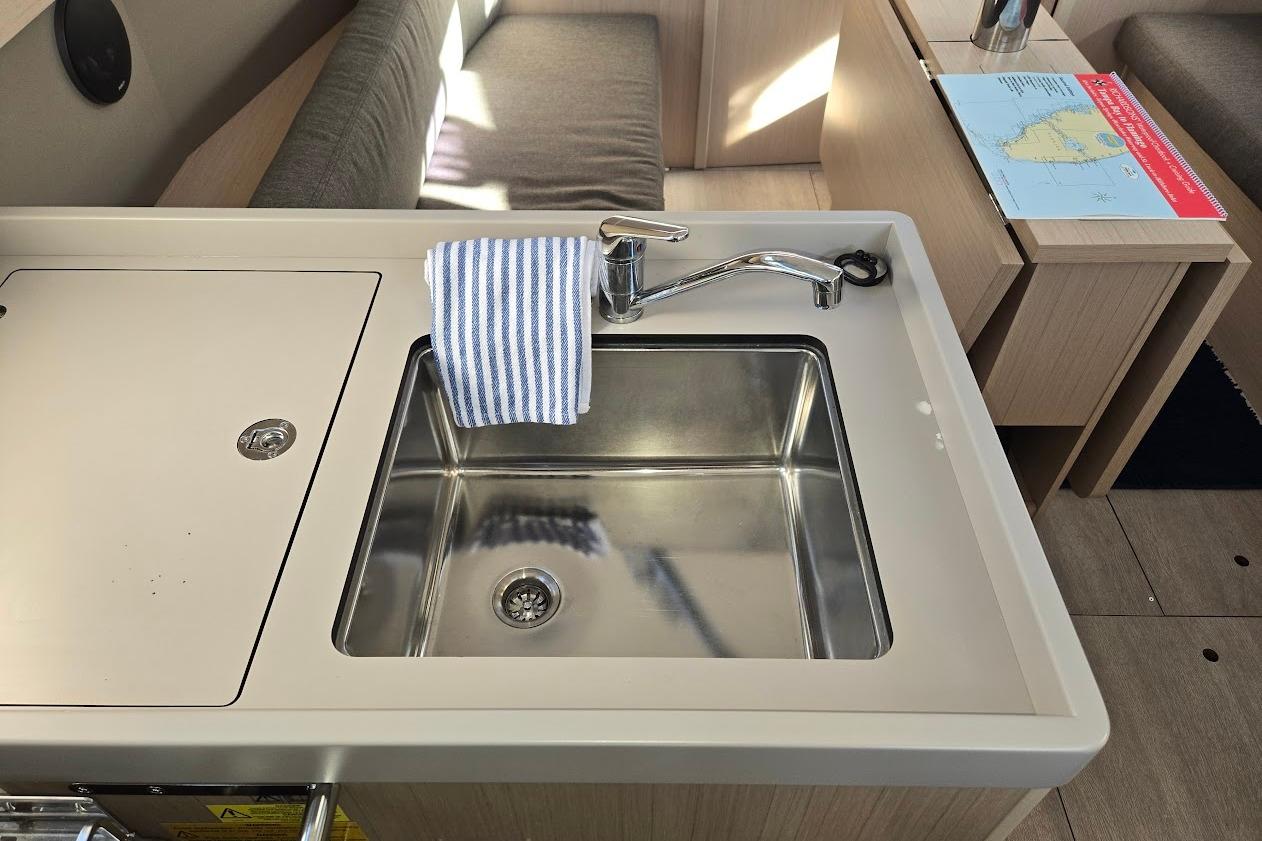 Modern kitchen sink in 2023 Beneteau Oceanis 38.1 yacht interior.