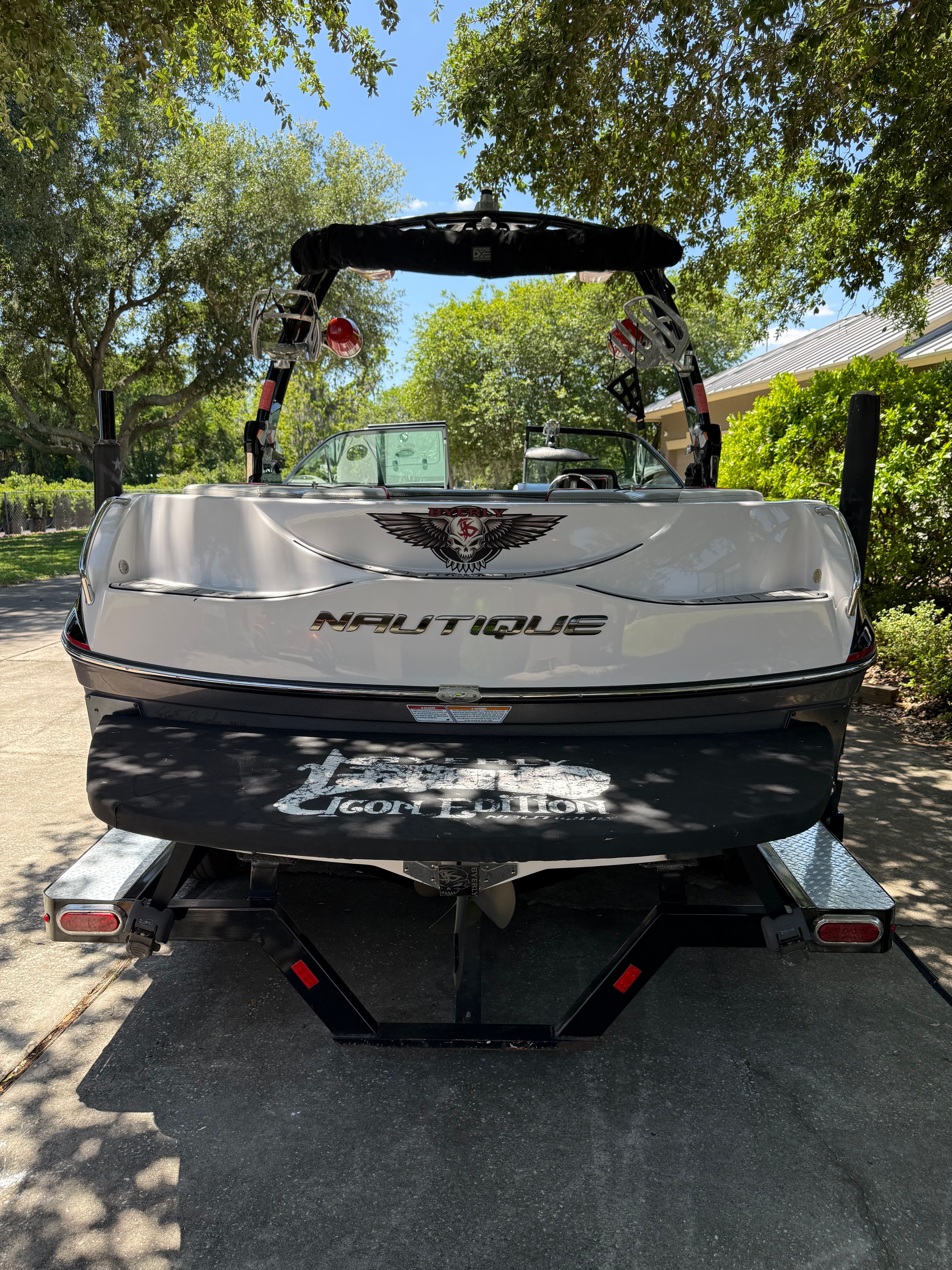 2012 Nautique Super Air Nautique 210 parked on trailer outdoors.