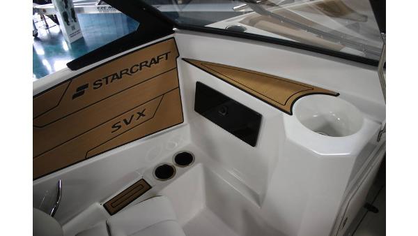 Interior of 2025 Starcraft SVX 190 OB DC boat with cup holders and branding.