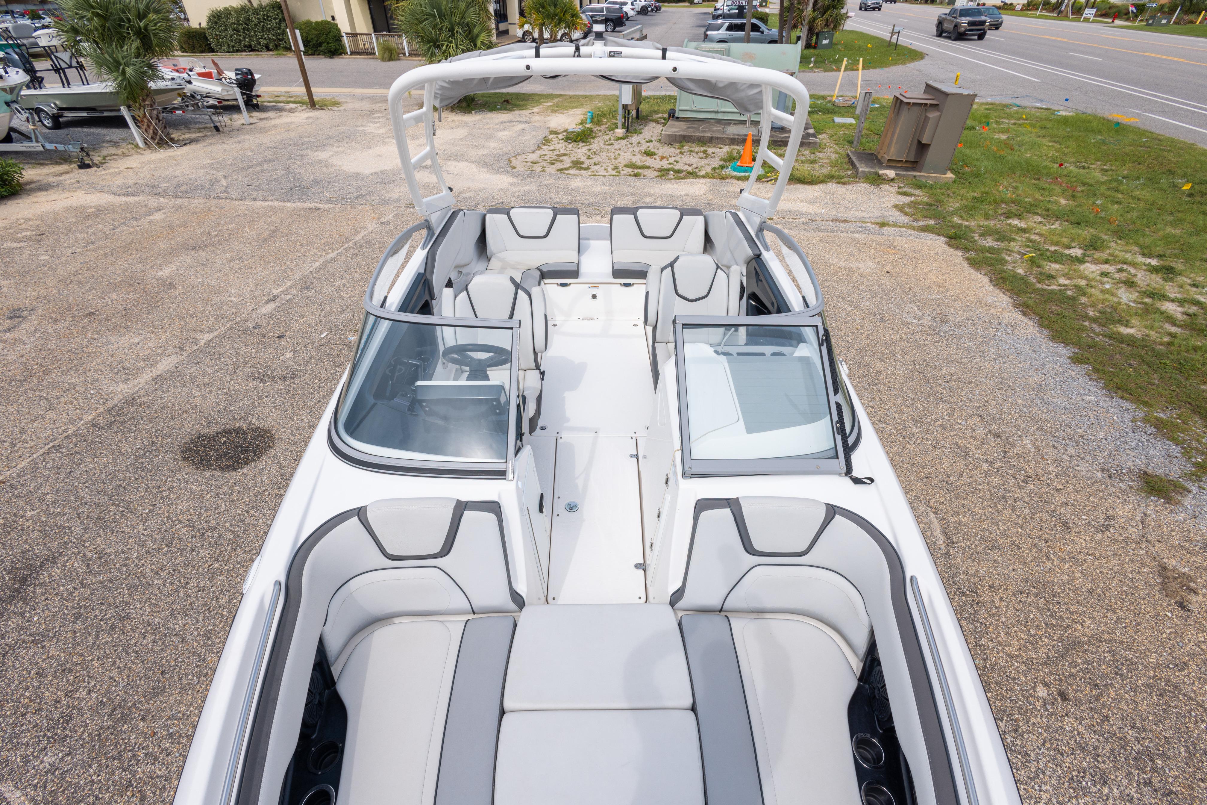 2021 Yamaha Boats AR250, spacious interior, sleek design, parked on a gravel lot.