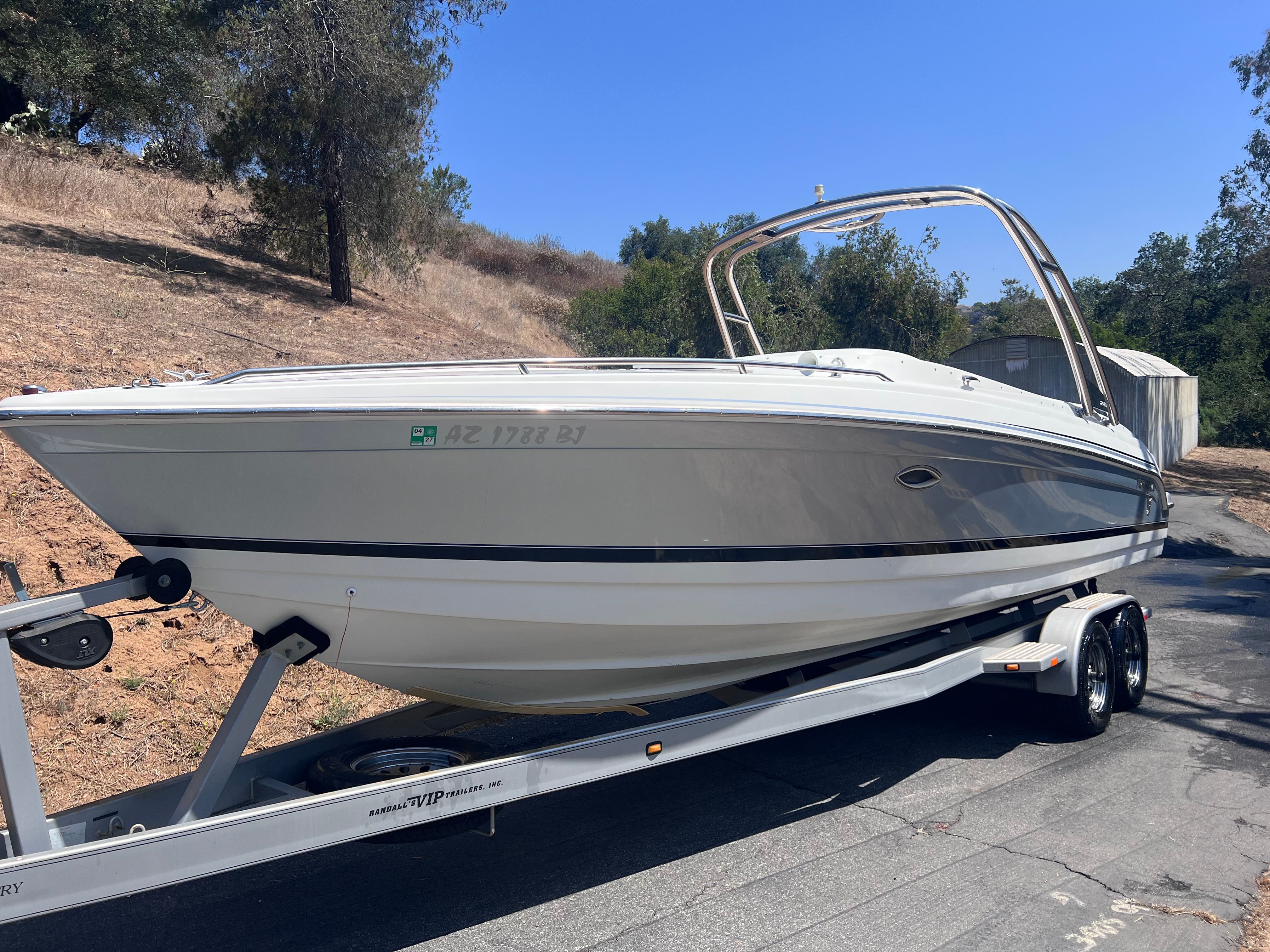 2006 Formula 260 Sun Sport boat on trailer outdoors.
