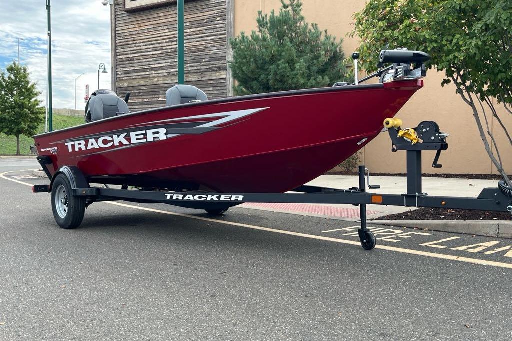 2026 Tracker Super Guide V-16 T boat on trailer, parked outdoors.