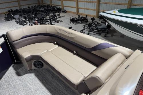 2026 Bennington 22SXSB pontoon boat interior with beige seating and speaker system.
