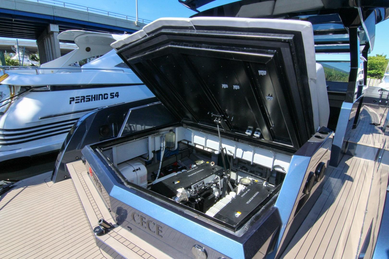 Open engine compartment of 2022 Vanquish Yachts VQ45, docked beside Pershing 54 yacht.