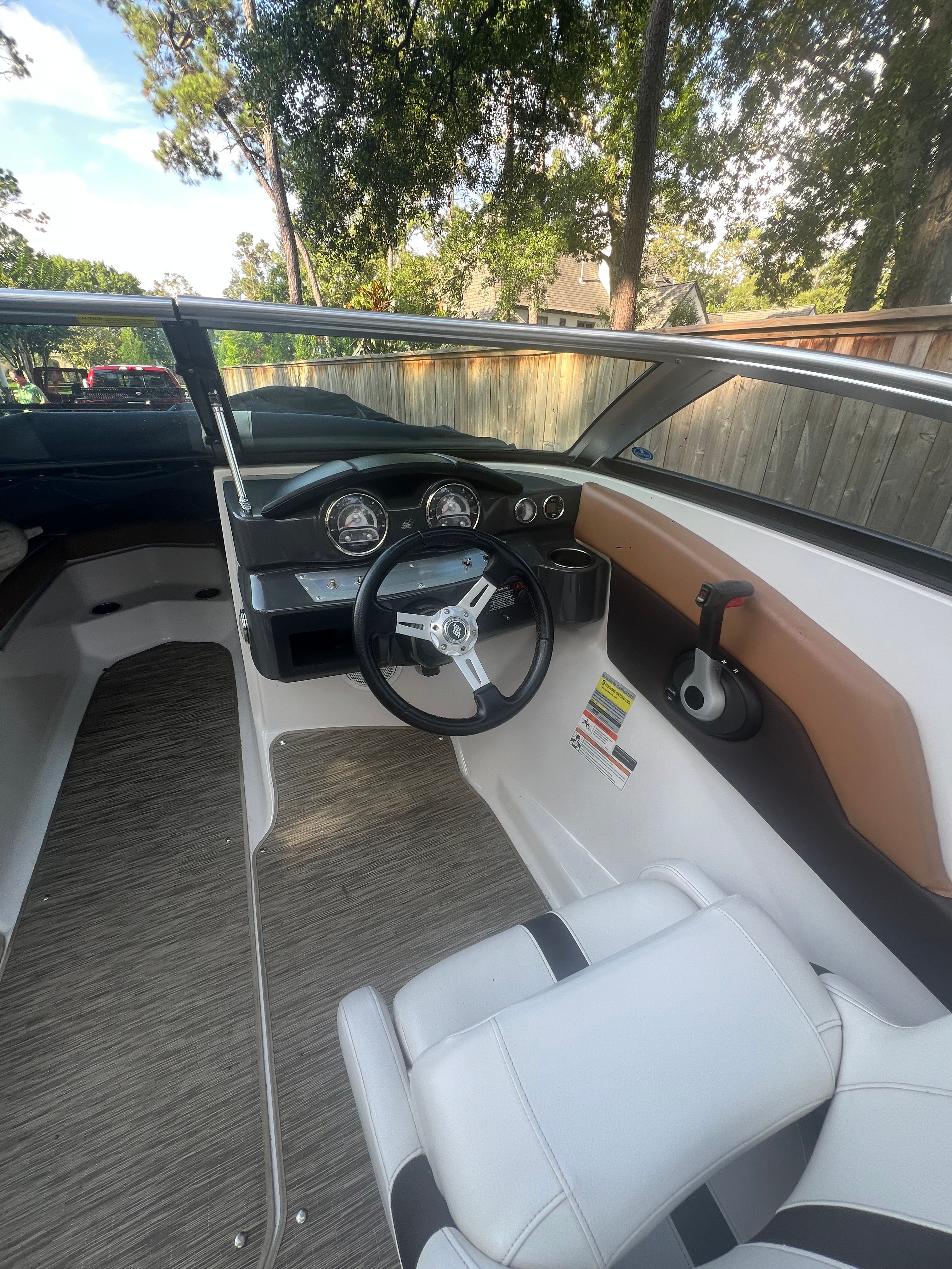 Interior view of a 2017 Four Winns H230 boat with steering console.