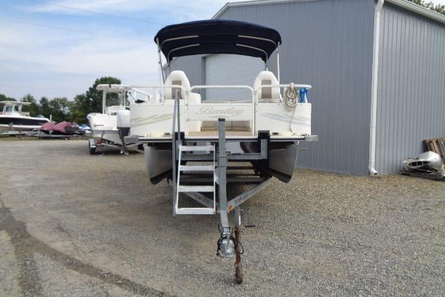 2008 Bentley Pontoons 200 CRUISE on trailer, parked outside a metal building.
