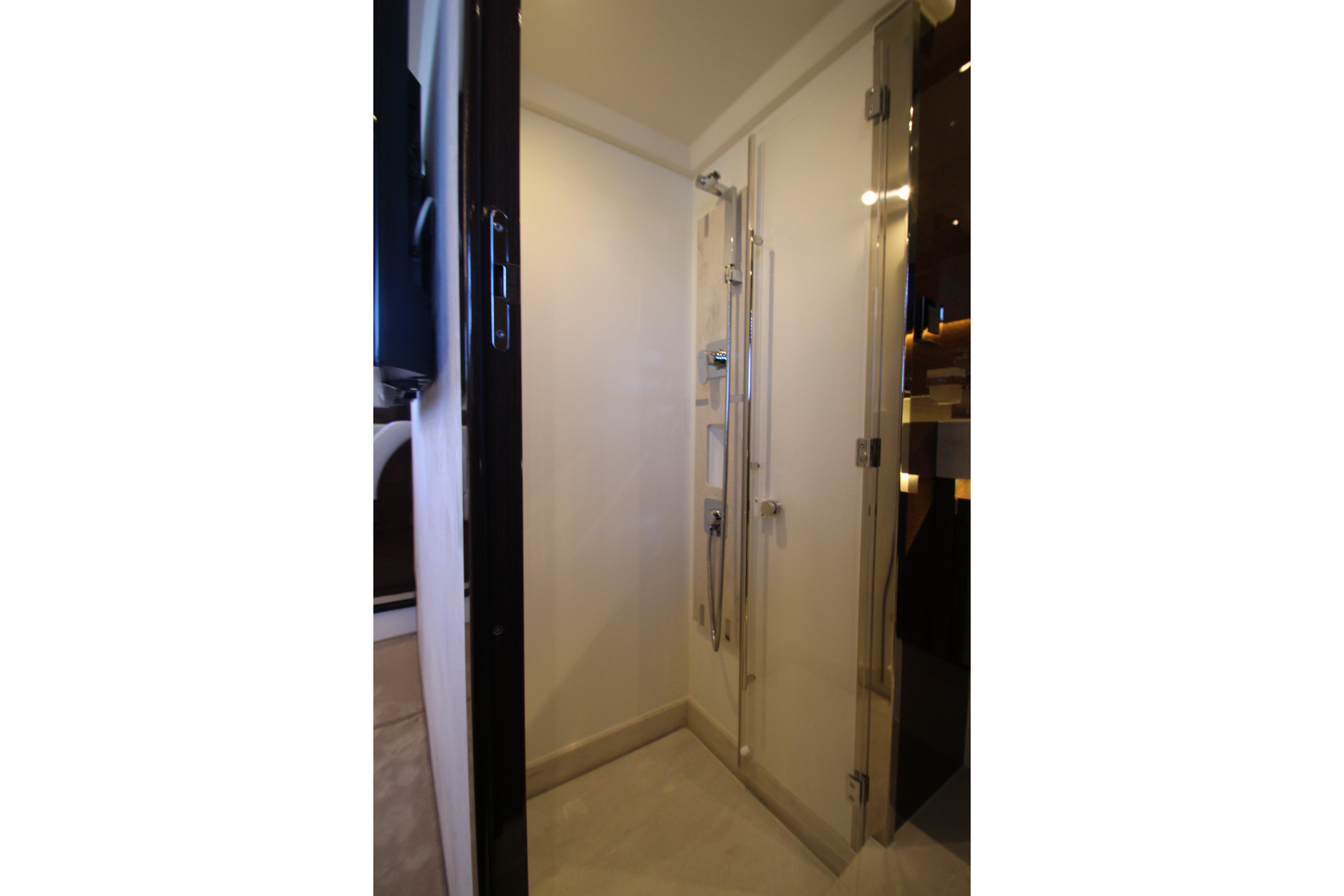 Modern shower area in 2022 Prestige 520 yacht, featuring sleek design and glass door.