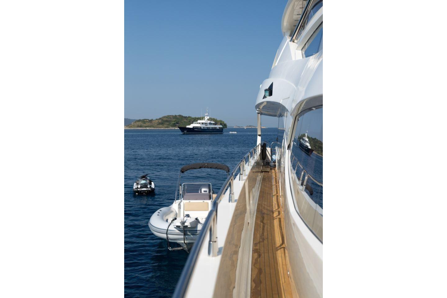 Sunseeker 34 Metre Yacht (2009) on serene blue waters with distant island view.