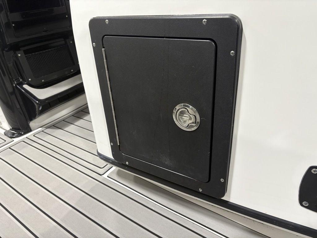 Storage compartment on 2026 Tidewater 2700 CB boat with sleek design and secure latch.