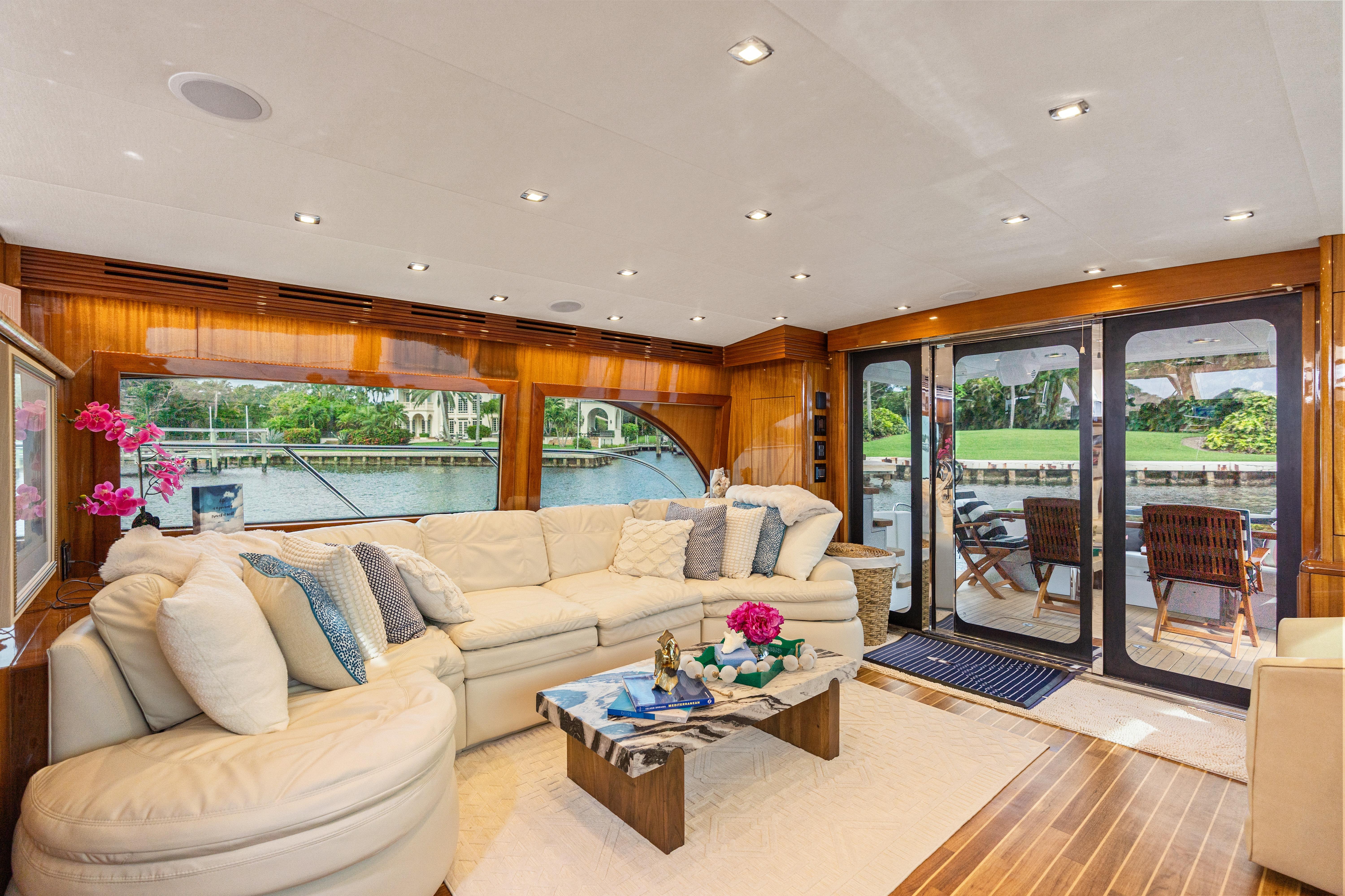 Luxurious interior of 2008 Hatteras 64 Motor Yacht with elegant seating and scenic views.
