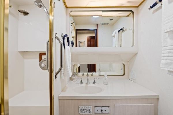 Bathroom interior of 1989 Hatteras 70 Motor Yacht with shower and vanity.