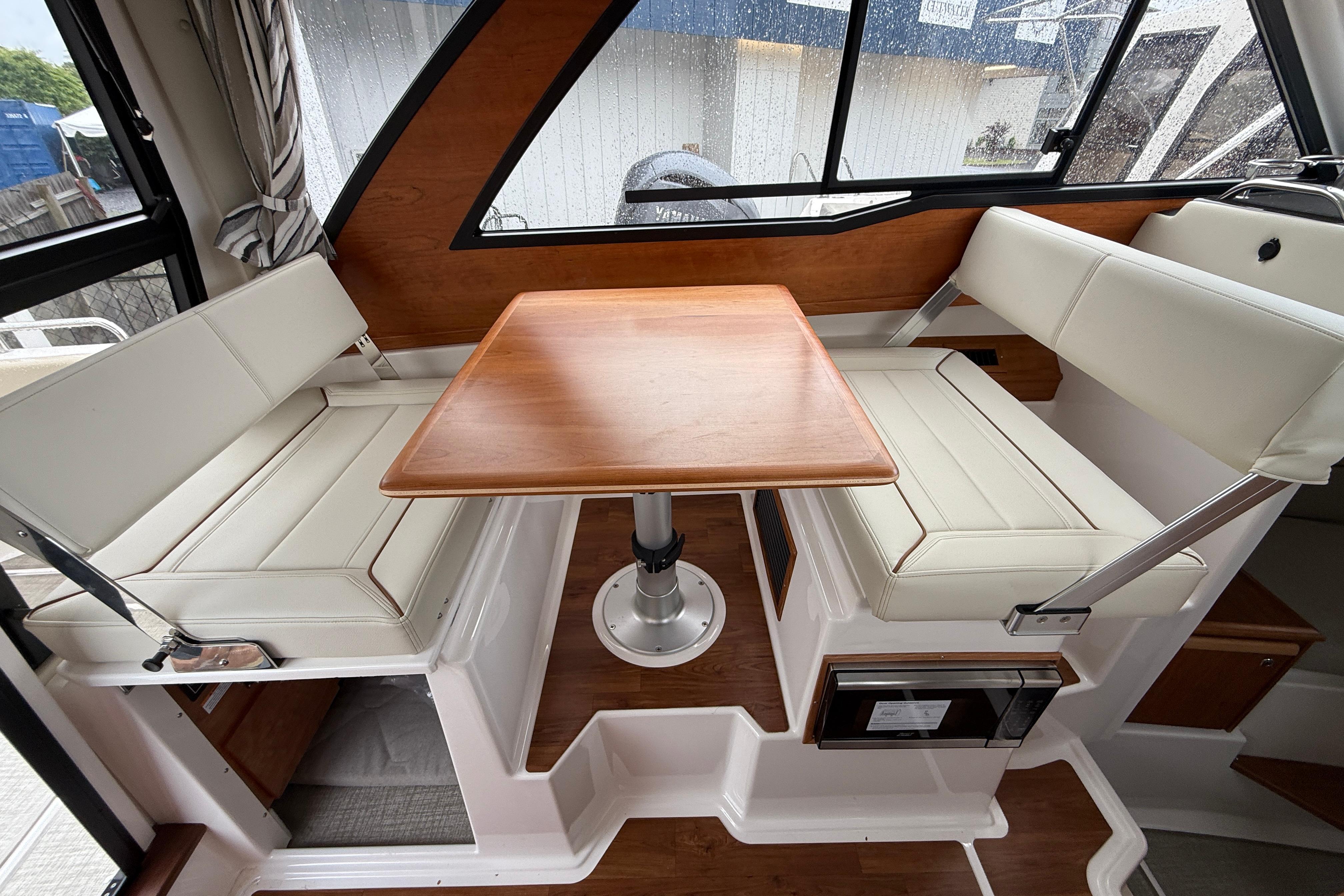 Interior of 2026 Cutwater C-248 Coupe featuring a cozy dining area with wooden table.