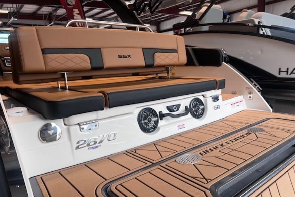 2025 Chaparral 2870 SSX boat with luxurious seating and sleek design in showroom.