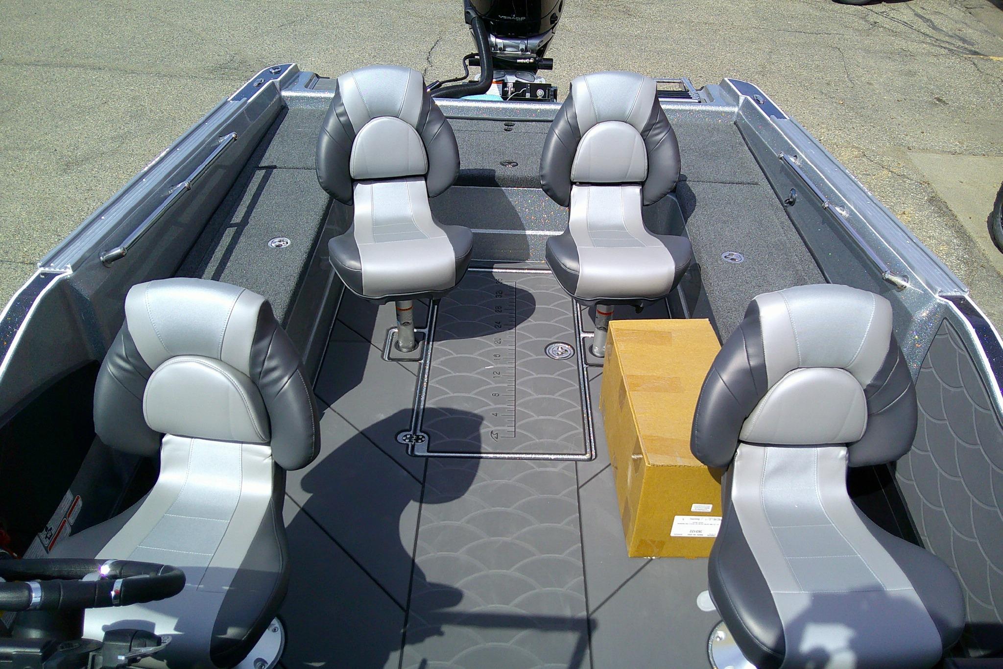 Interior of 2026 Nitro ZV21 Pro boat with four seats and a cardboard box.