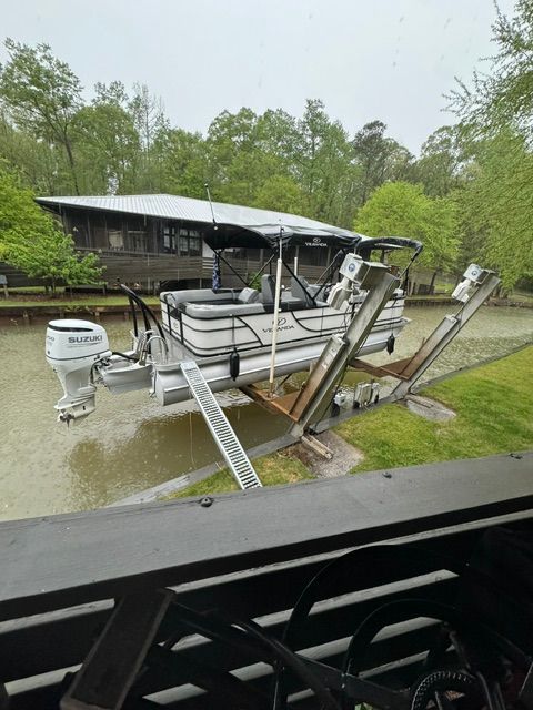 Veranda VR22RC 2021 pontoon boat on lift by river.