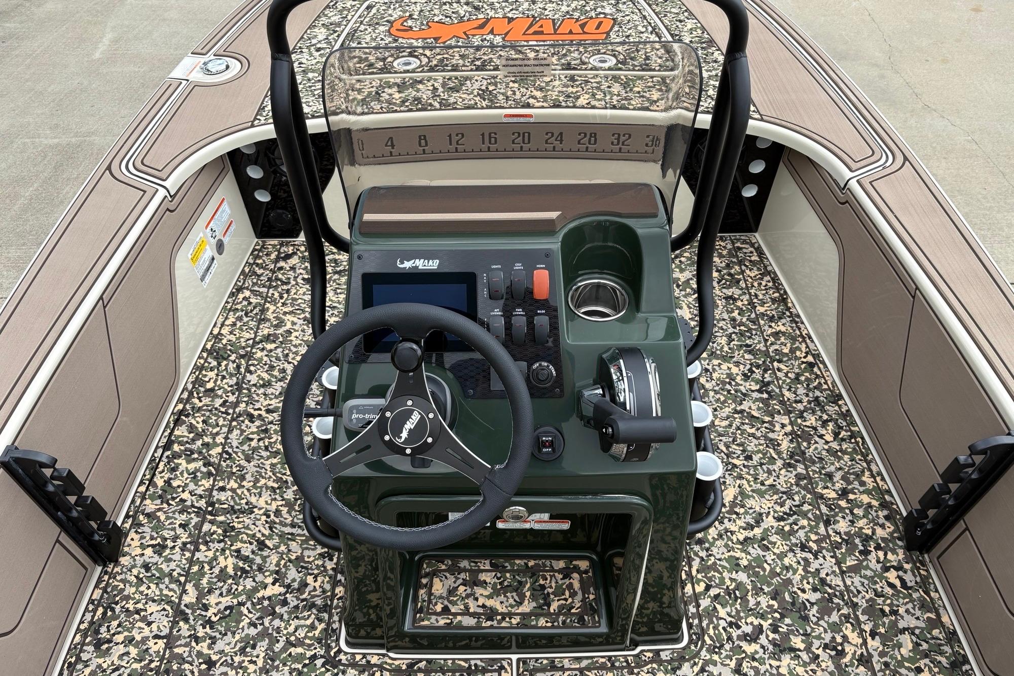 2025 Mako 18 Pro Skiff Backwater Edition boat interior with camo design and steering console.