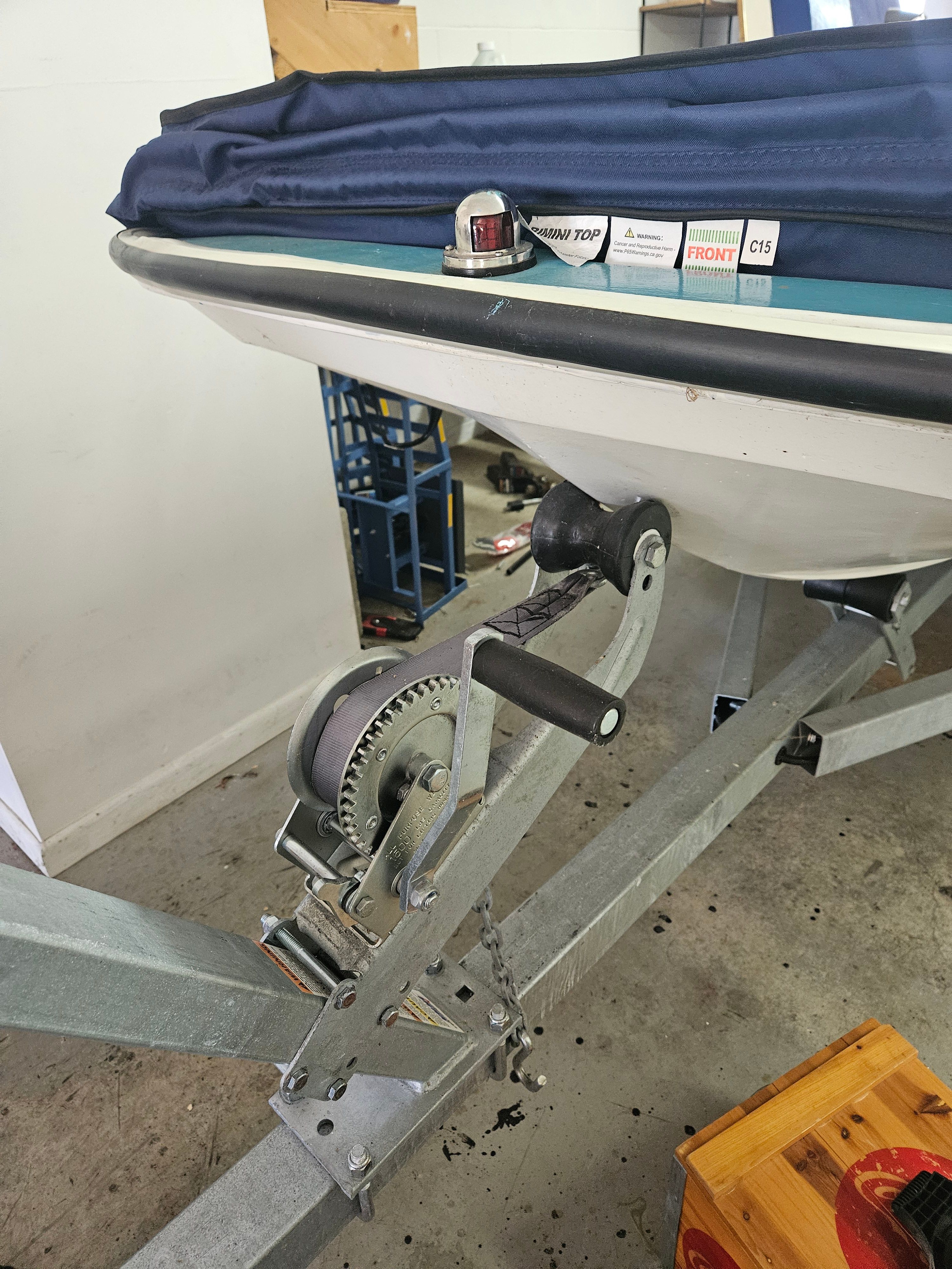 1977 Boston Whaler 14 on a trailer in a garage.