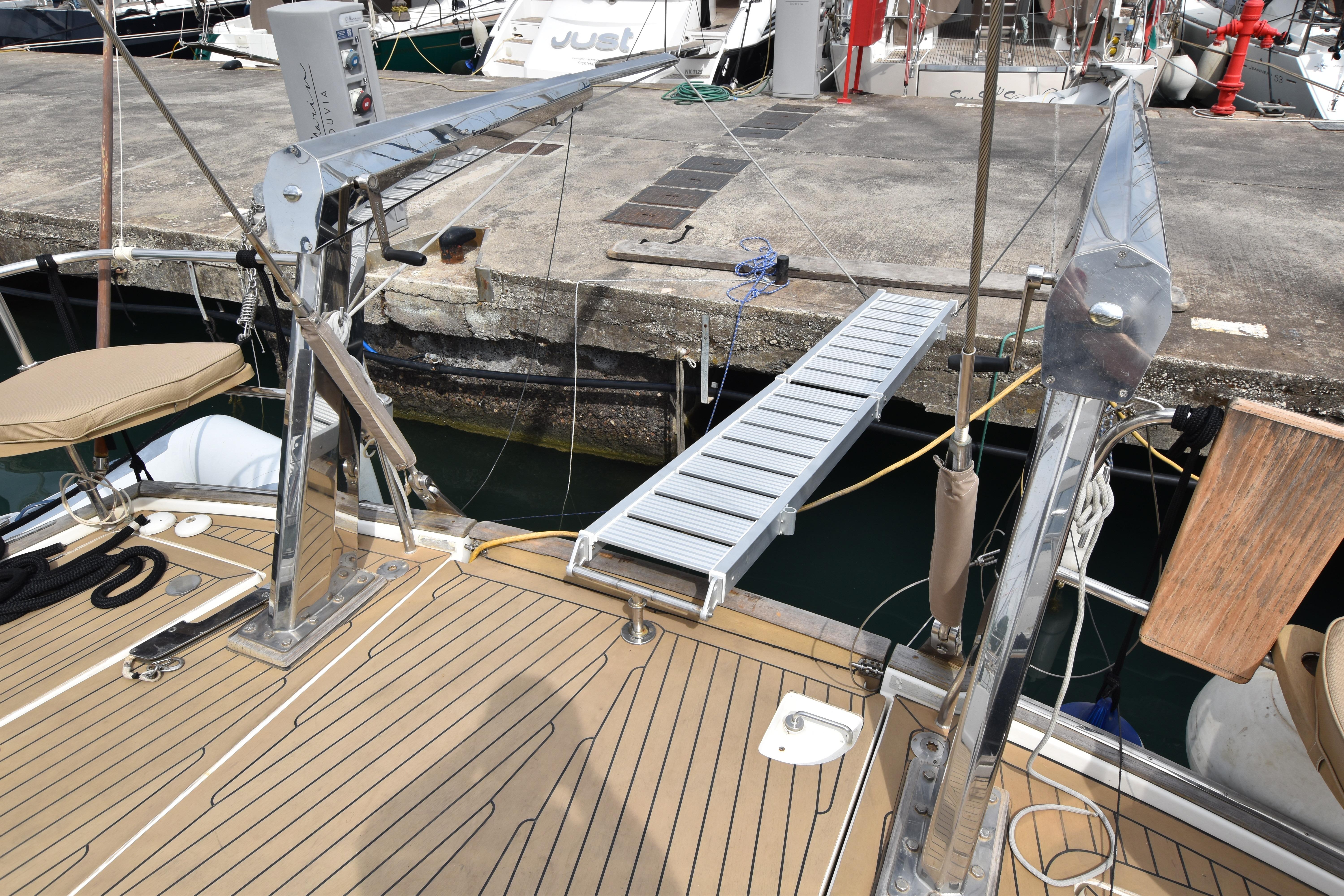 Beneteau 57 yacht deck with gangway, docked at marina, 2004 model.
