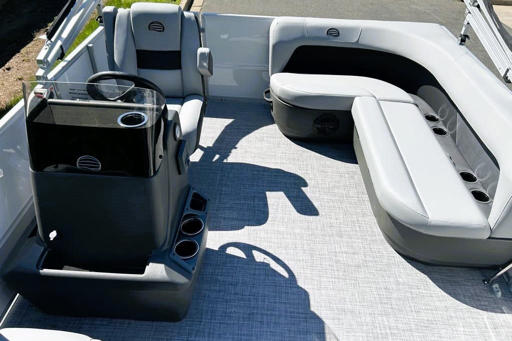 2026 Sun Tracker Party Barge 16 DLX interior with plush seating and modern helm.