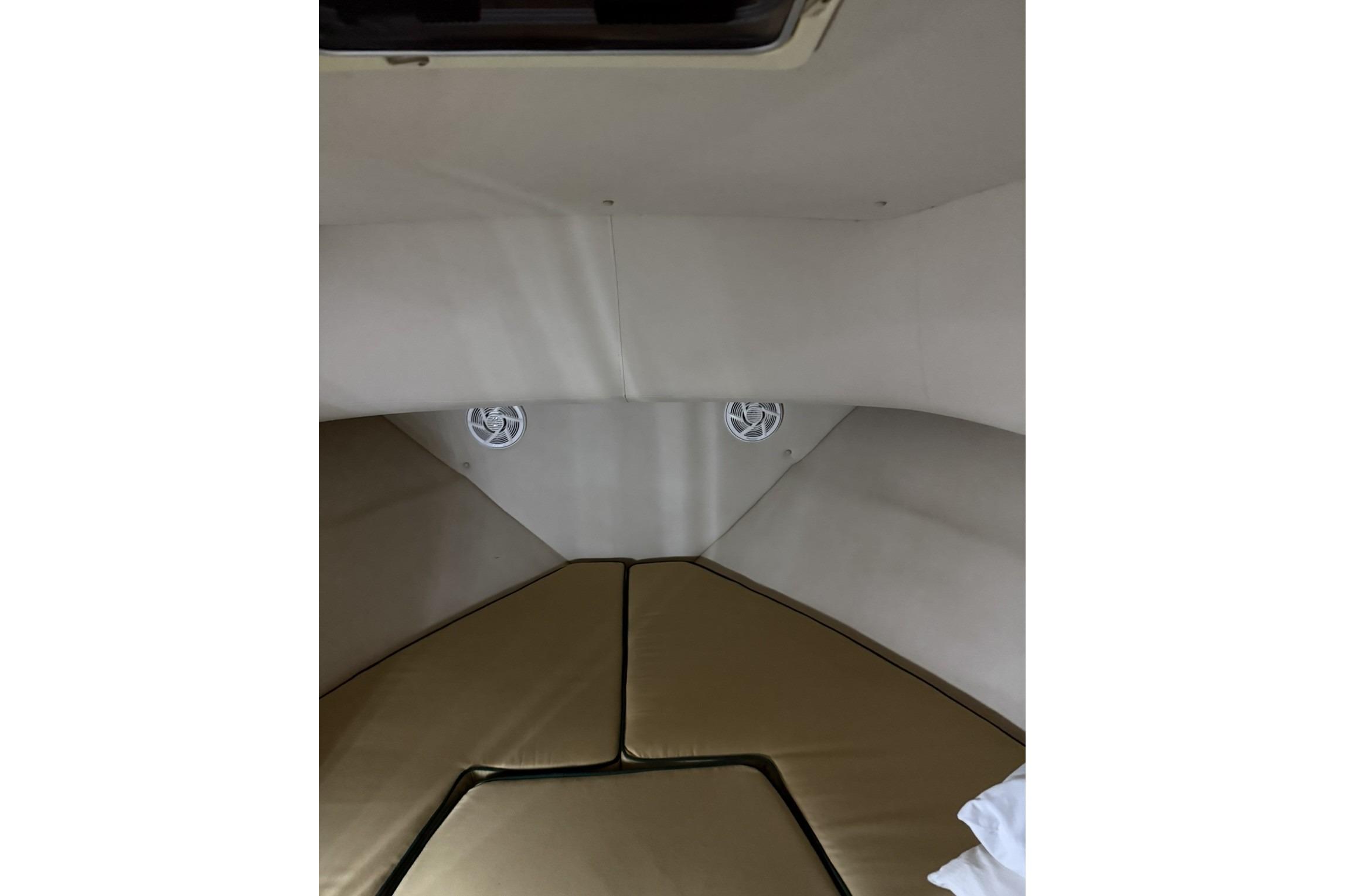 Interior cabin of 2000 Pursuit 3070 Offshore Center Console boat with cushioned seating.