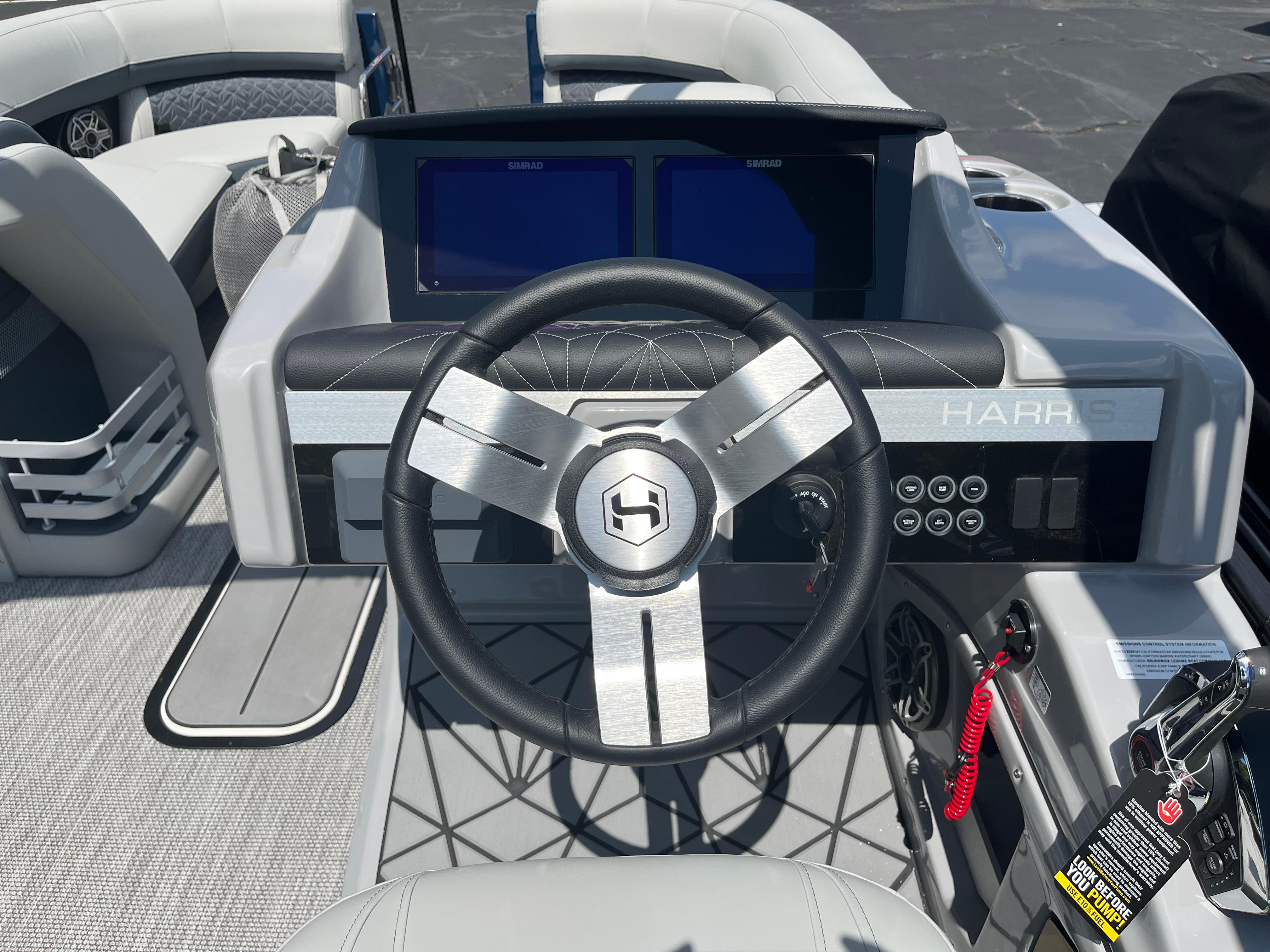 Steering console of 2026 Harris Grand Mariner 230 boat with modern controls and displays.
