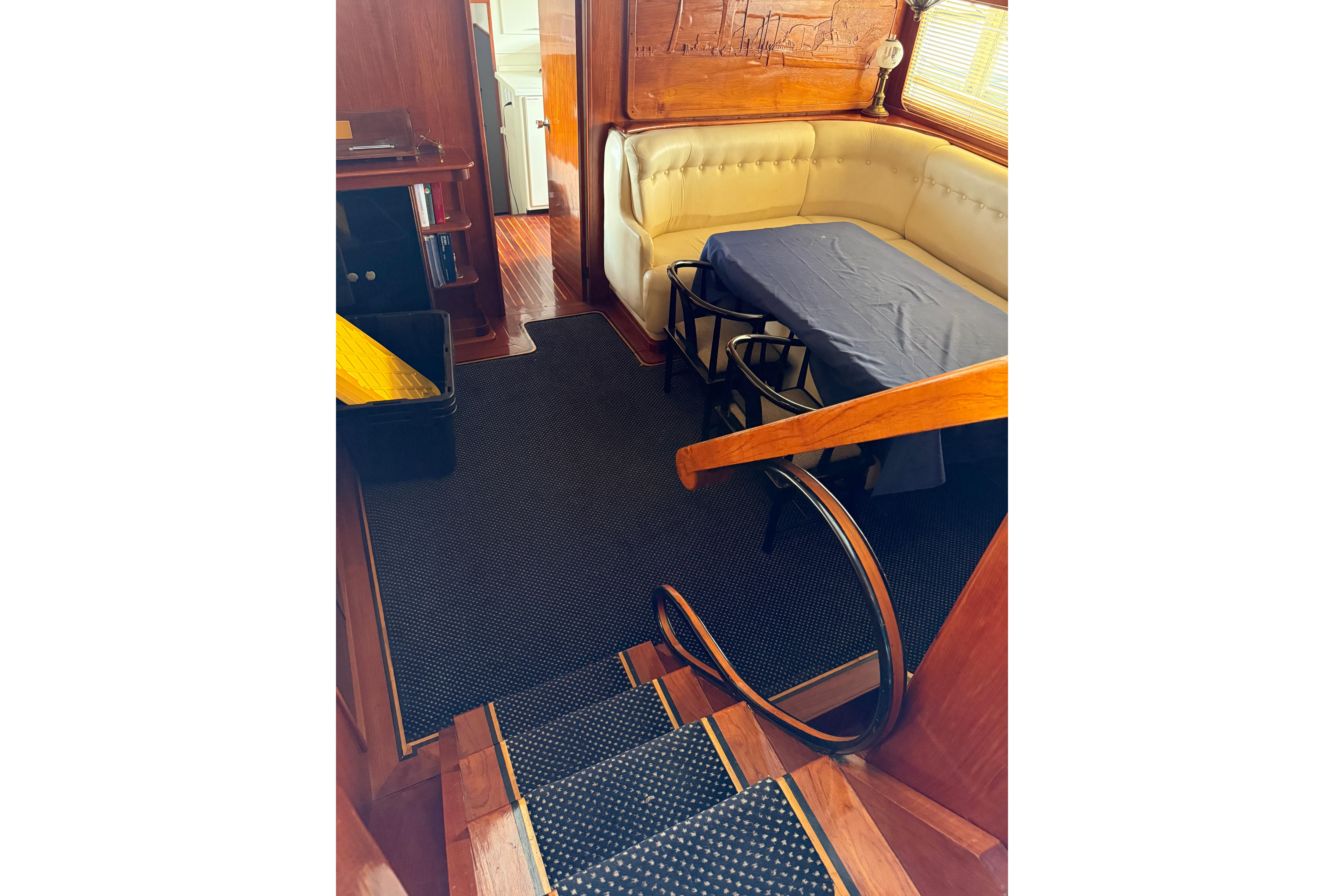 Interior of 1974 Pacemaker Cockpit Motoryacht with dining area and wooden accents.