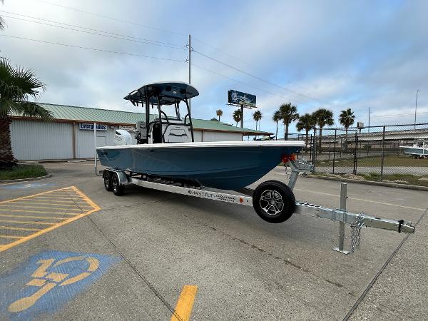 2024 Sea Pro 250 DLX boat on trailer in parking lot, palm trees in background.