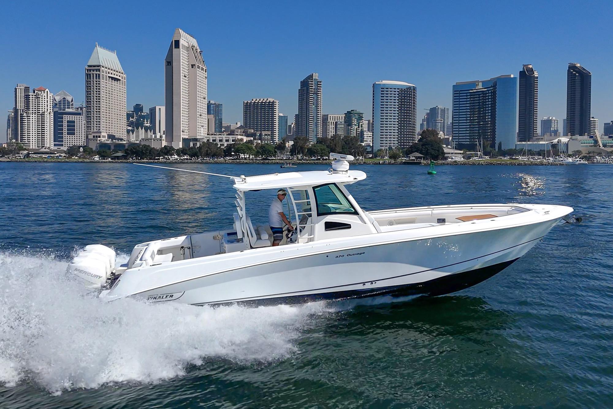 2015 Boston Whaler 370 Outrage cruising in urban waterfront setting.