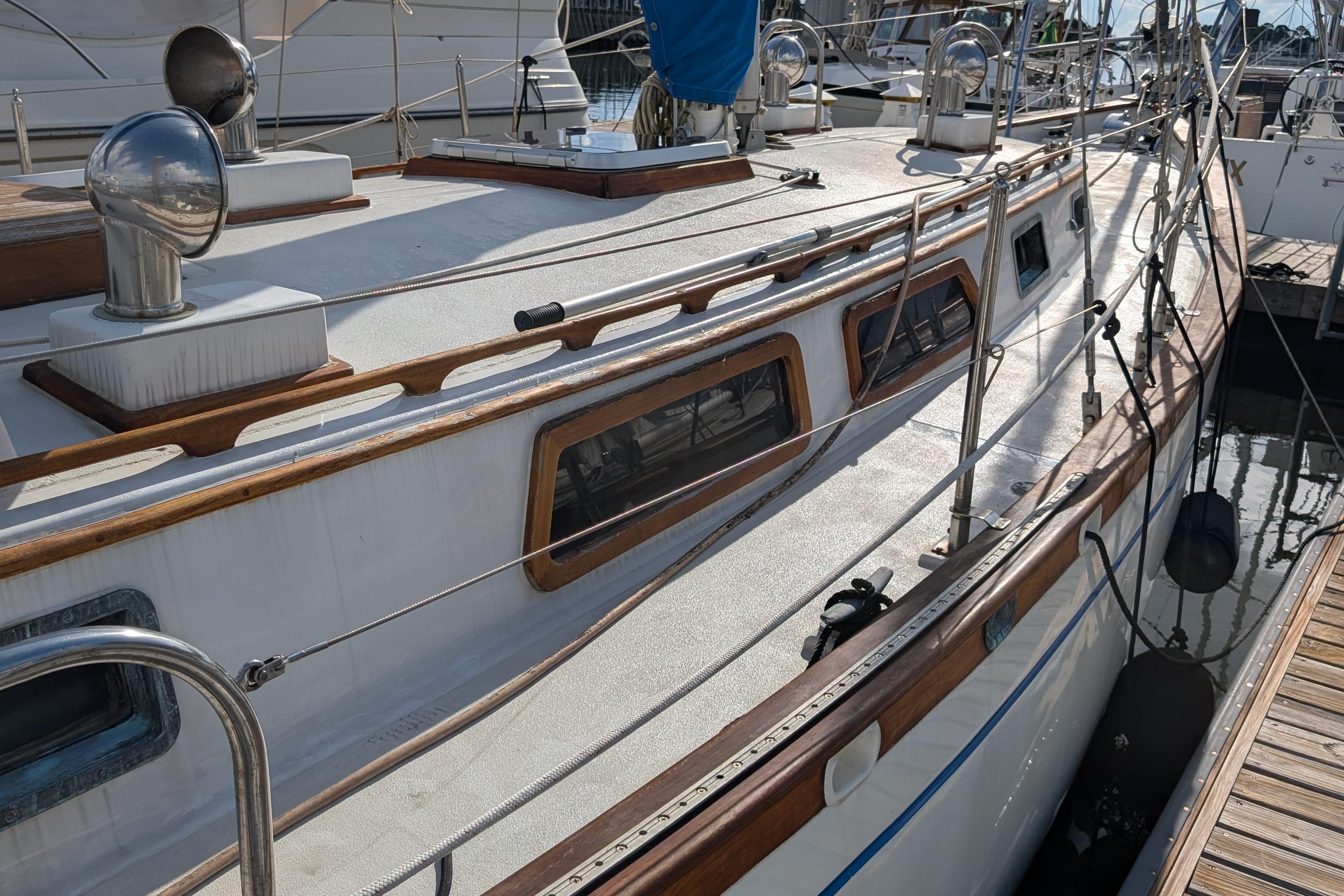 1983 Robert Perry 41 sailboat docked, showcasing deck and cabin details.