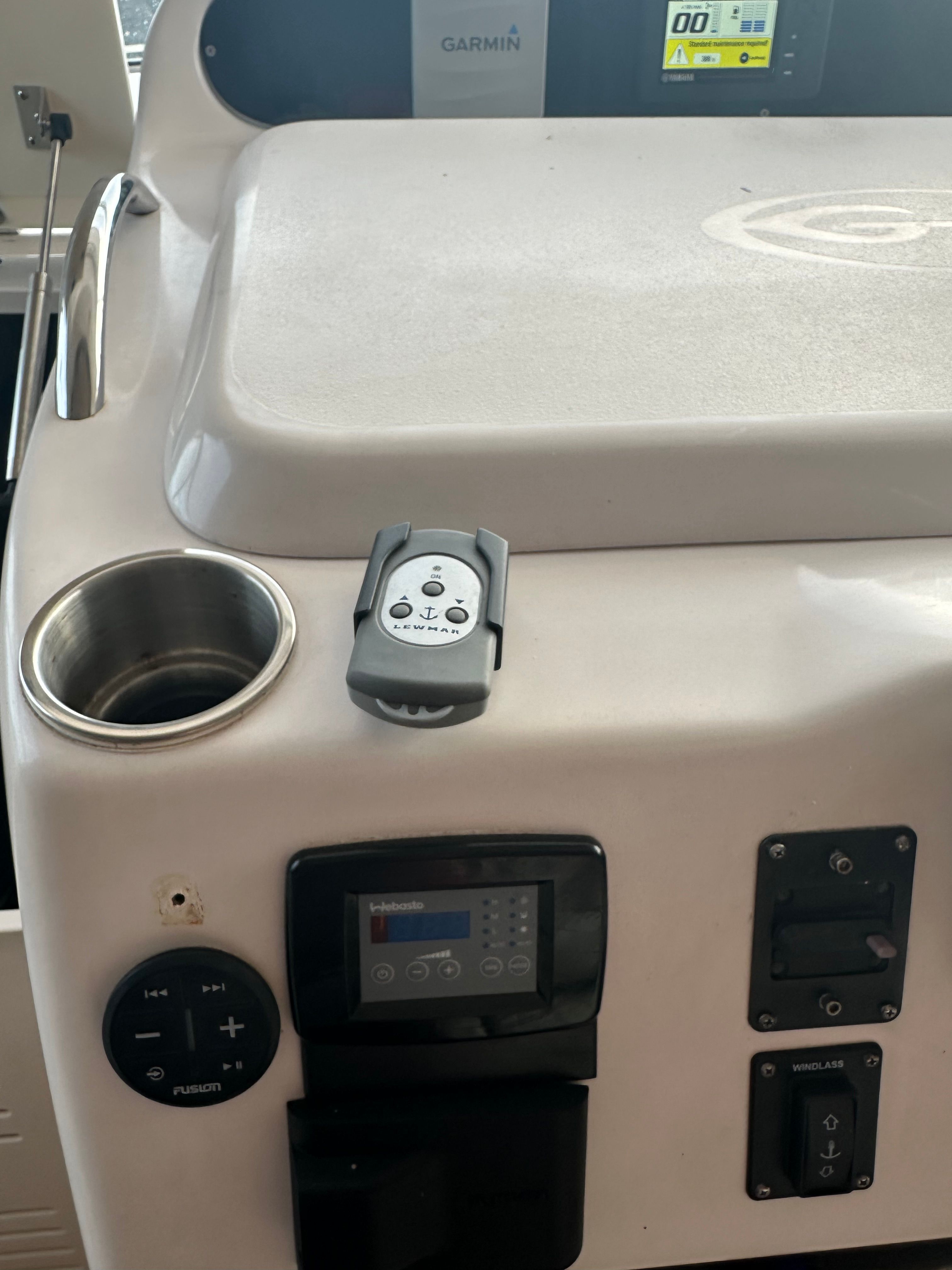 Control console of a Grady-White Express 330 with controls and a cup holder.