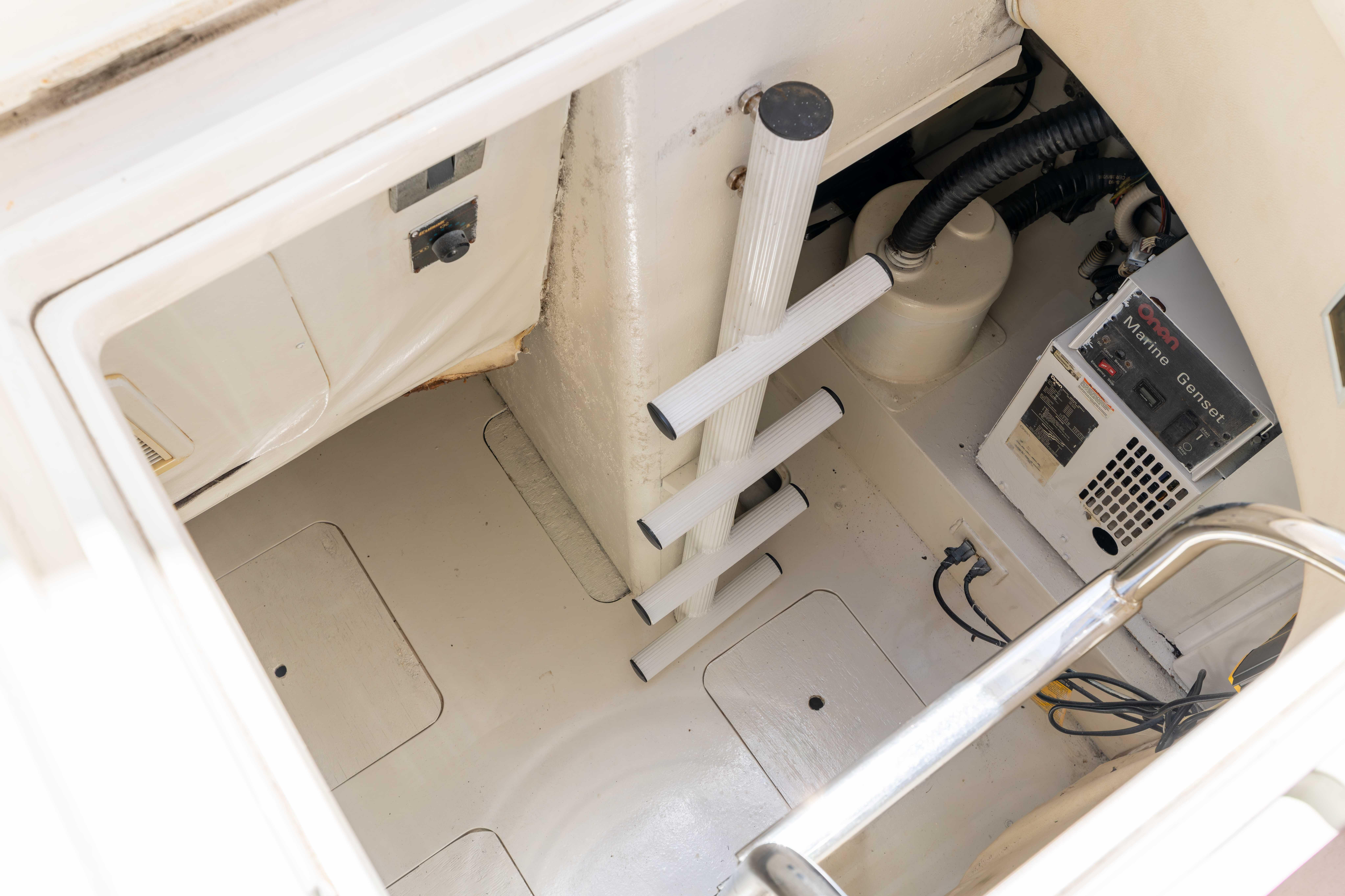 Engine room of a 2002 Princess 61 yacht with ladder and marine generator.