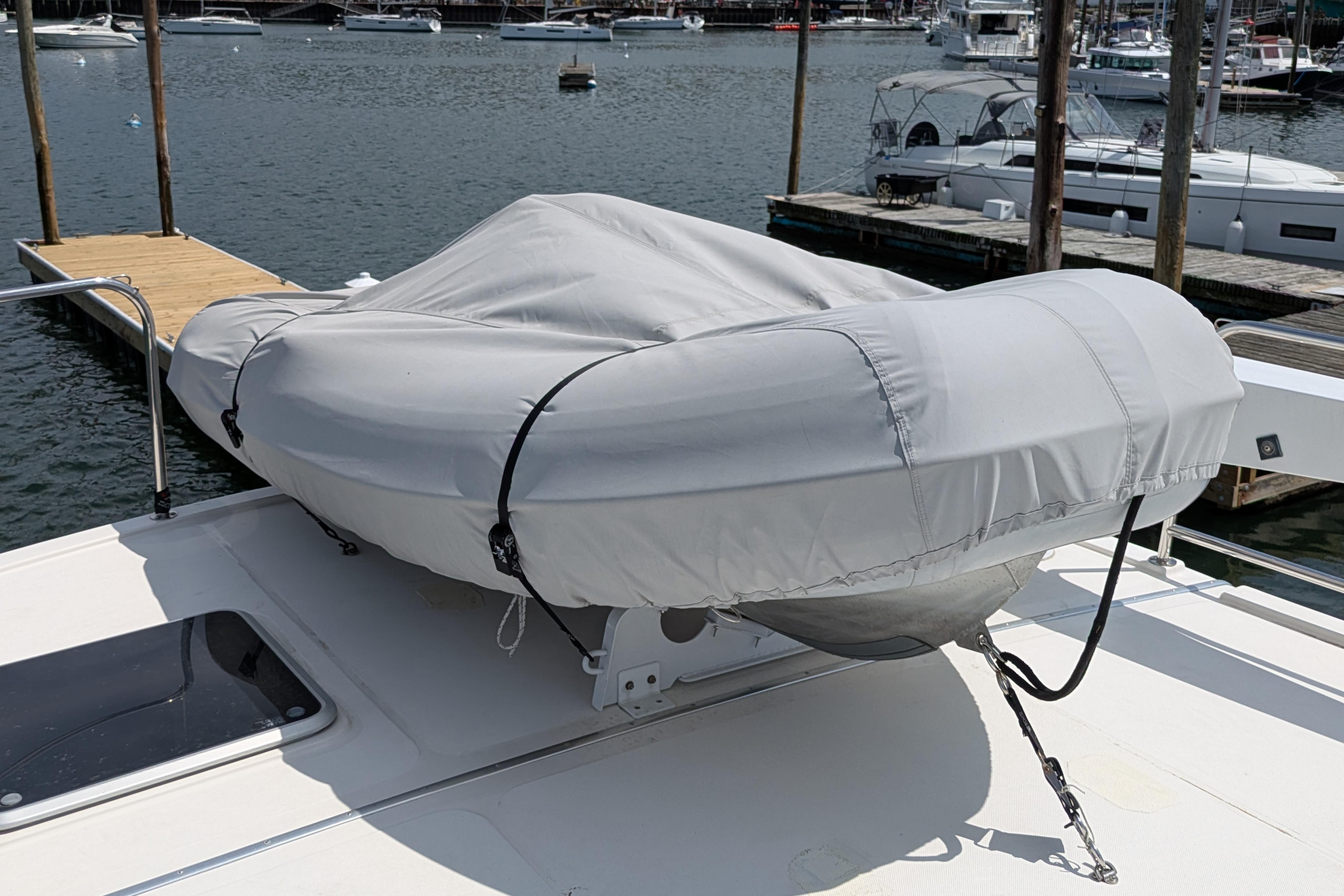 Covered dinghy on 2005 American Tug 41 yacht deck at marina.