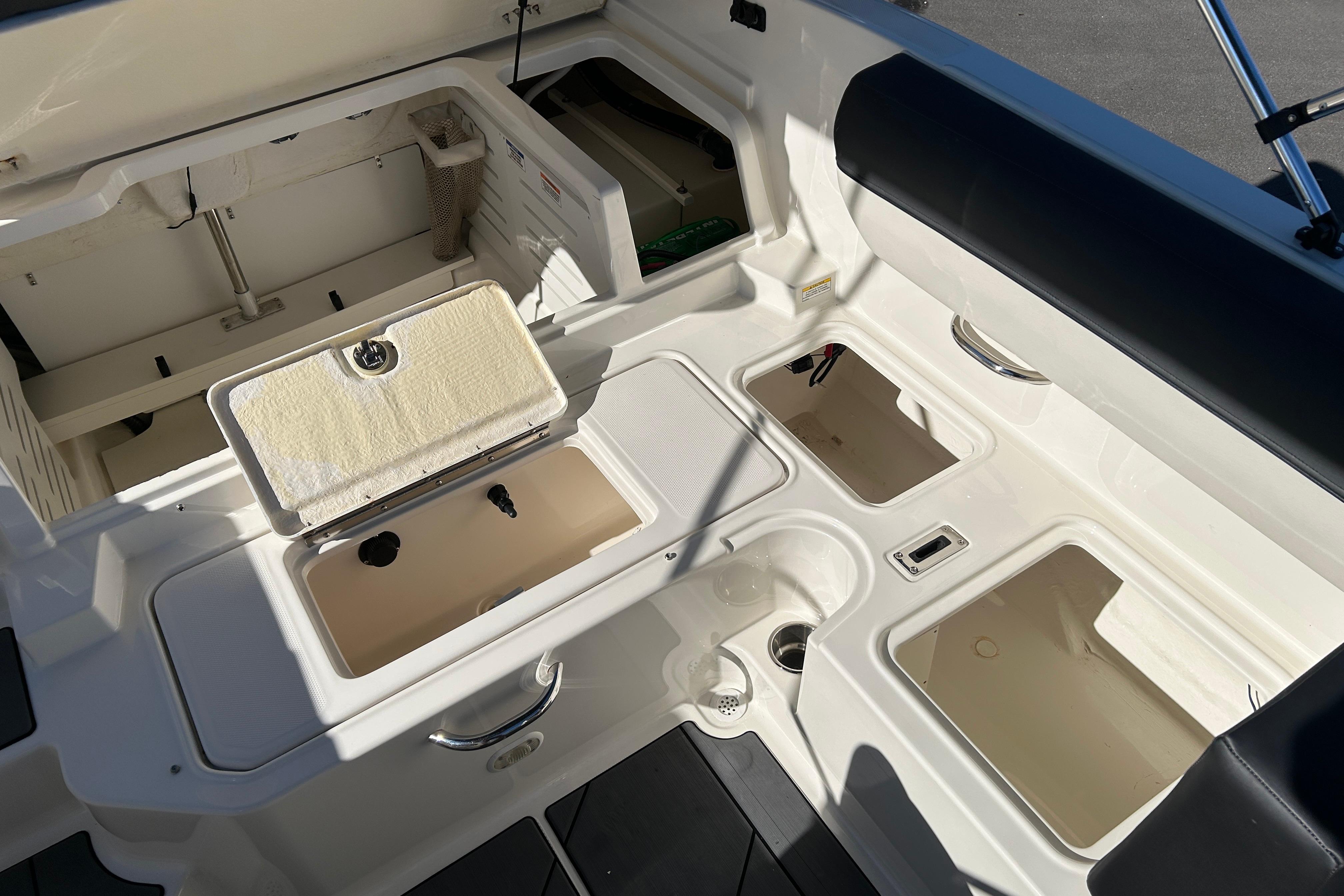 2020 Bayliner DX 2000 boat interior with storage compartments and seating.