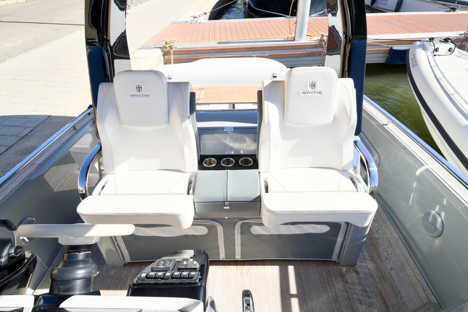 2023 Invictus GT320 boat interior with white seating and control panel.