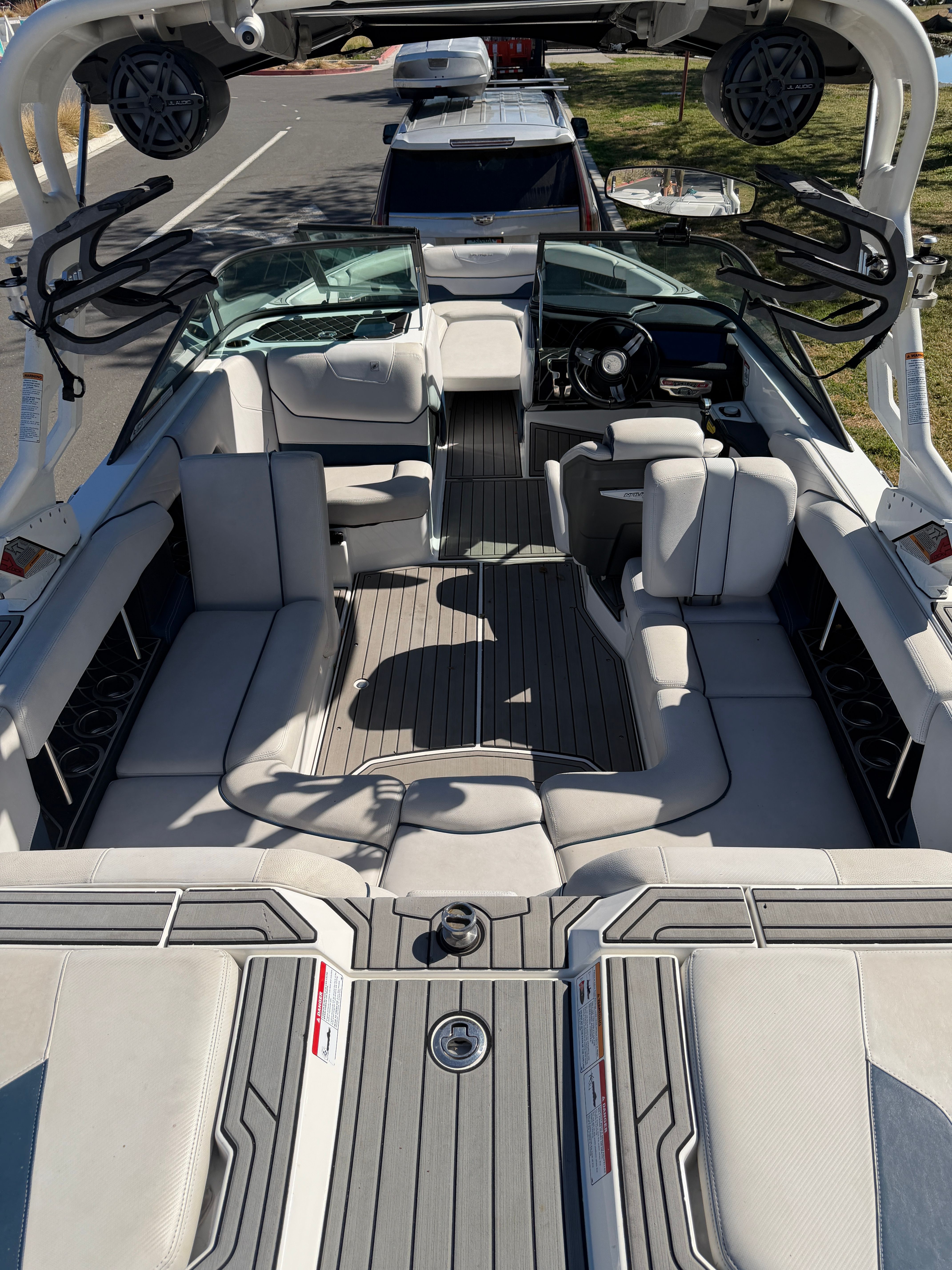 Interior view of a 2018 Nautique Super Air Nautique GS22 with gray upholstery and modern design.