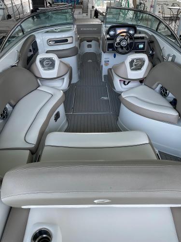 2019 Crownline E255 boat interior with beige seating and modern dashboard.