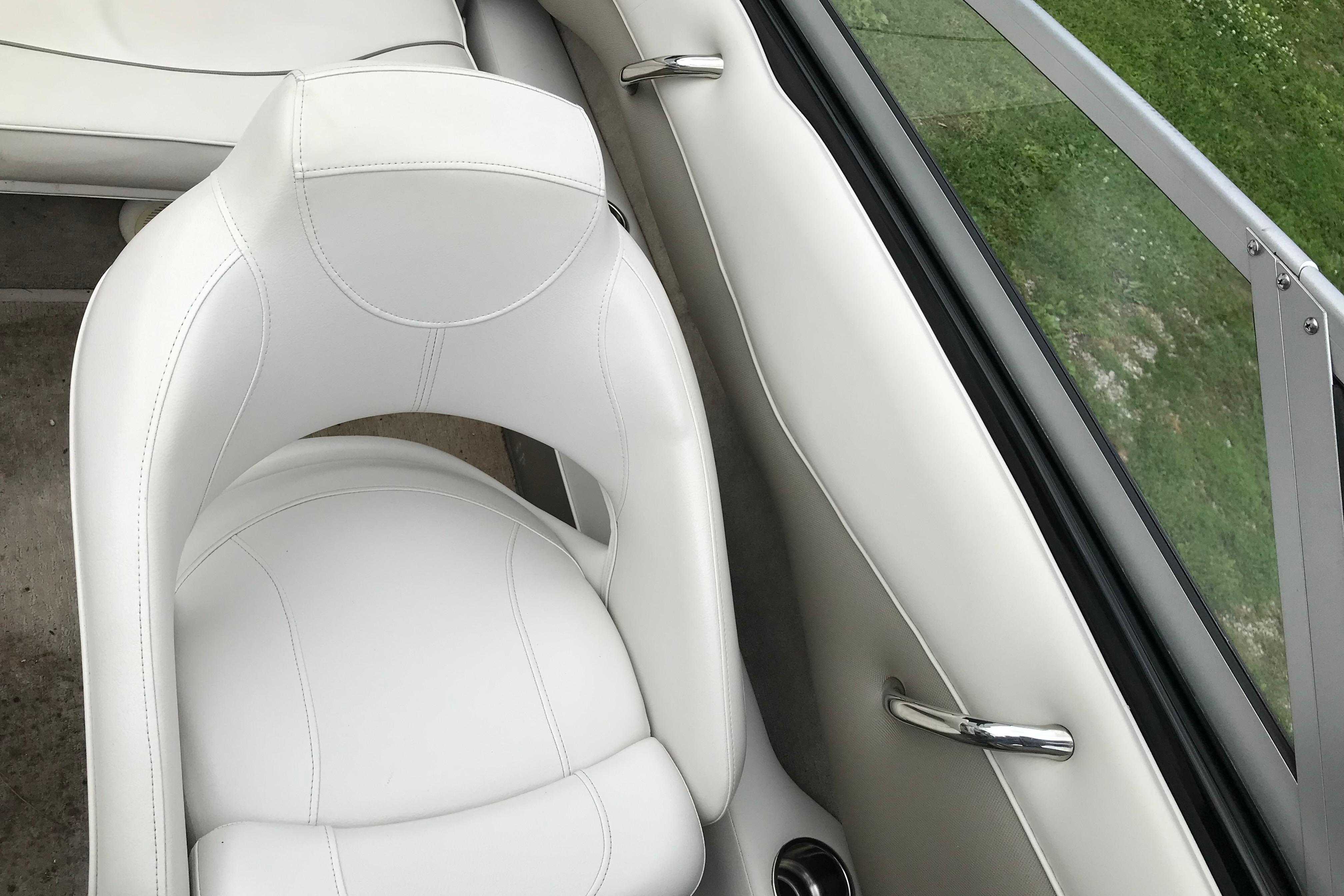 White leather seat in 2015 Crownline 18 SS boat interior, near window and handle.
