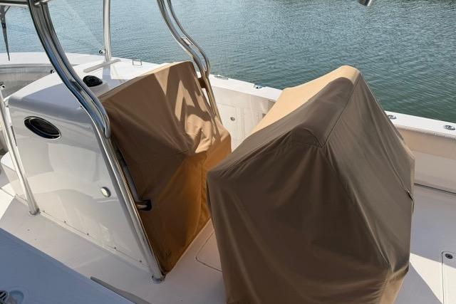 2014 Southport 29 FE boat with covered seats on a sunny day.