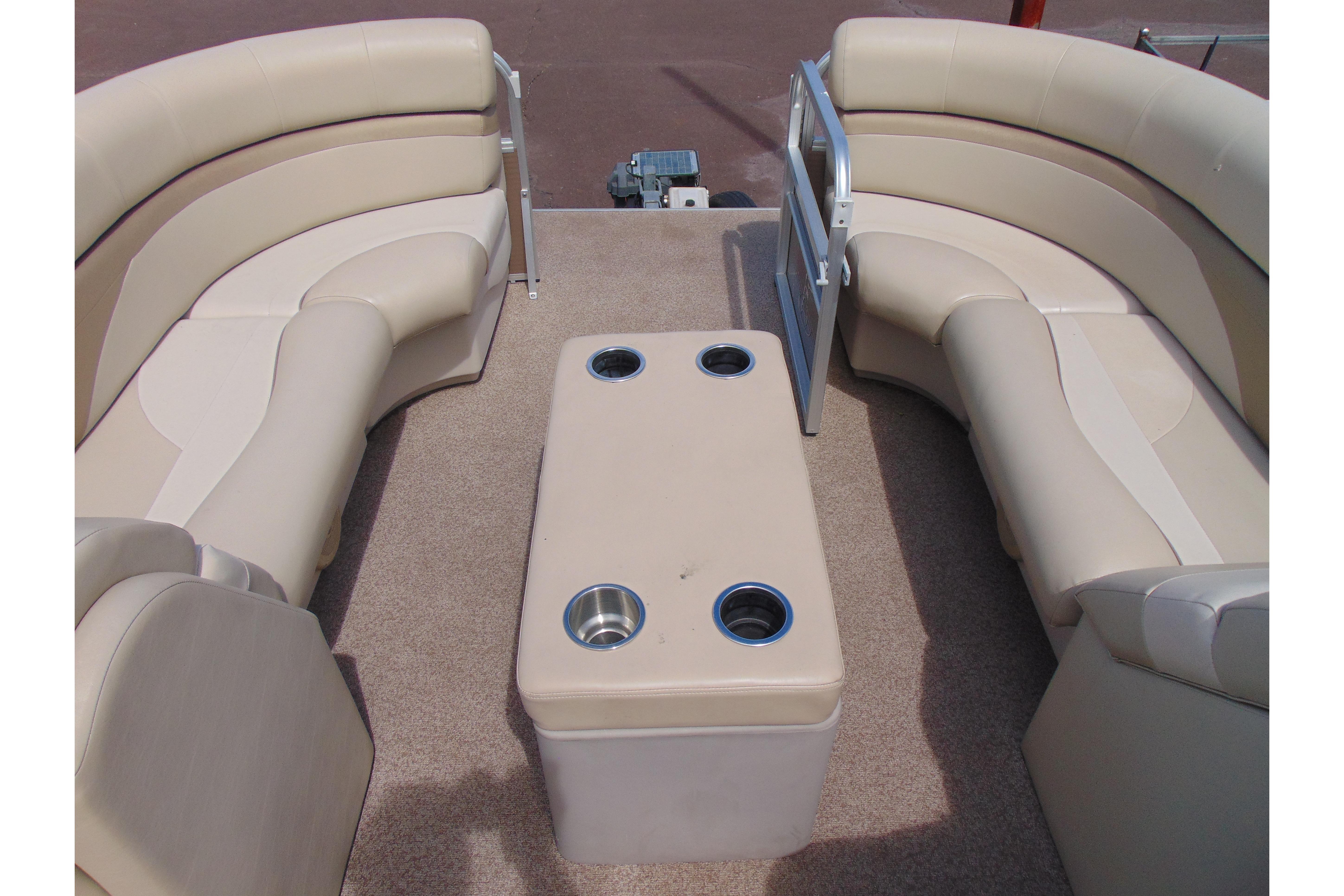 2016 Misty Harbor 245 Adventure CU boat interior with beige seating and cup holders.