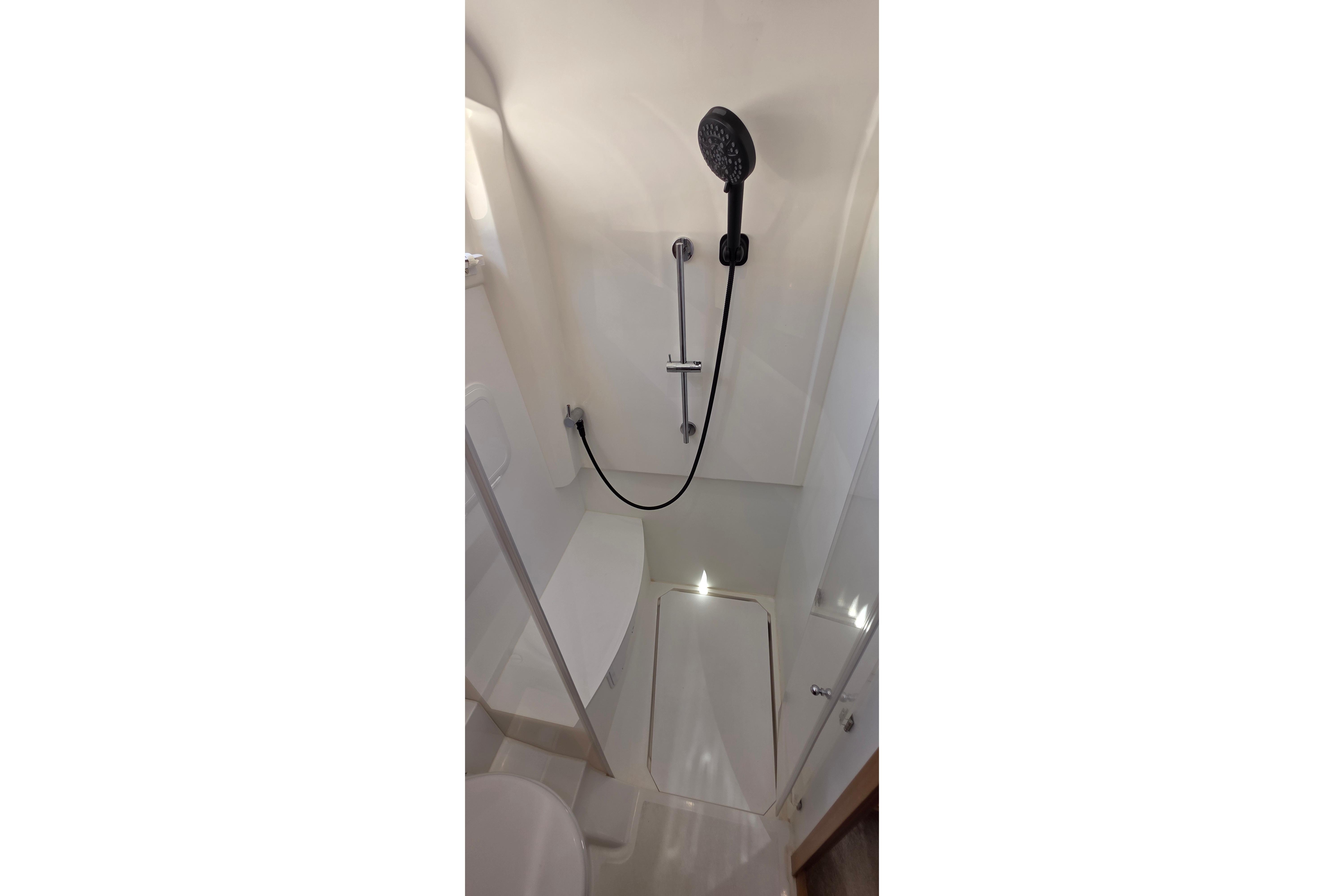 Modern shower area in 2023 Greenline 40 yacht bathroom.