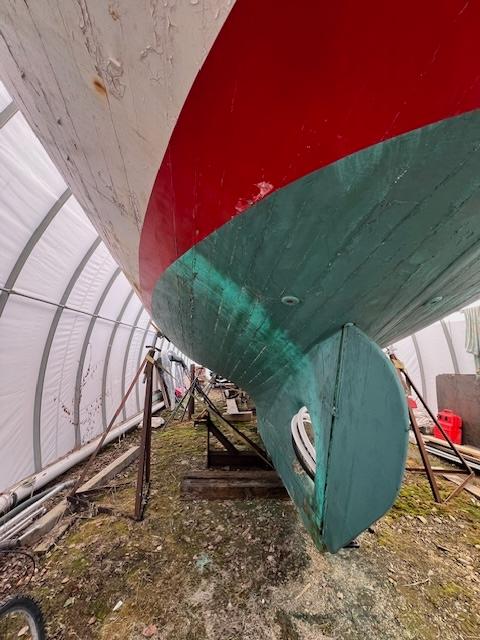 1917 Custom Bell Laboratories Yawl 59 under restoration in a covered boatyard.